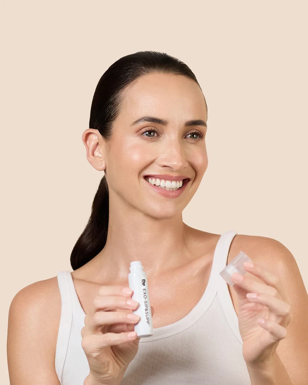 Step 3 of using EXO-SIP&SUPP. Model holding product with cap removed.