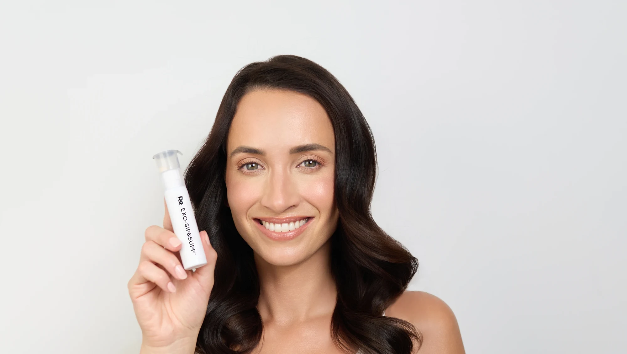 Image of model holding single unit of EXO-SIP&SUPP