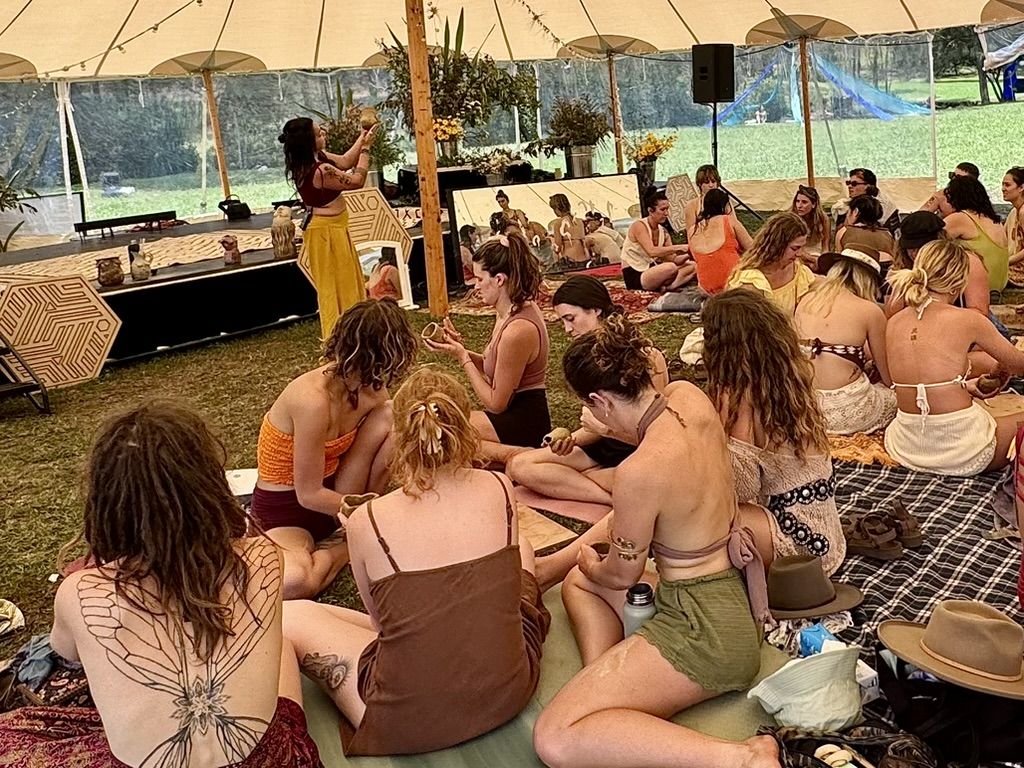 Manuela teaching to a large crowd of women at Ember Collaborative Gathering