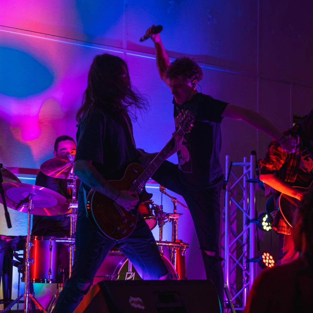 Band members performing live at a venue