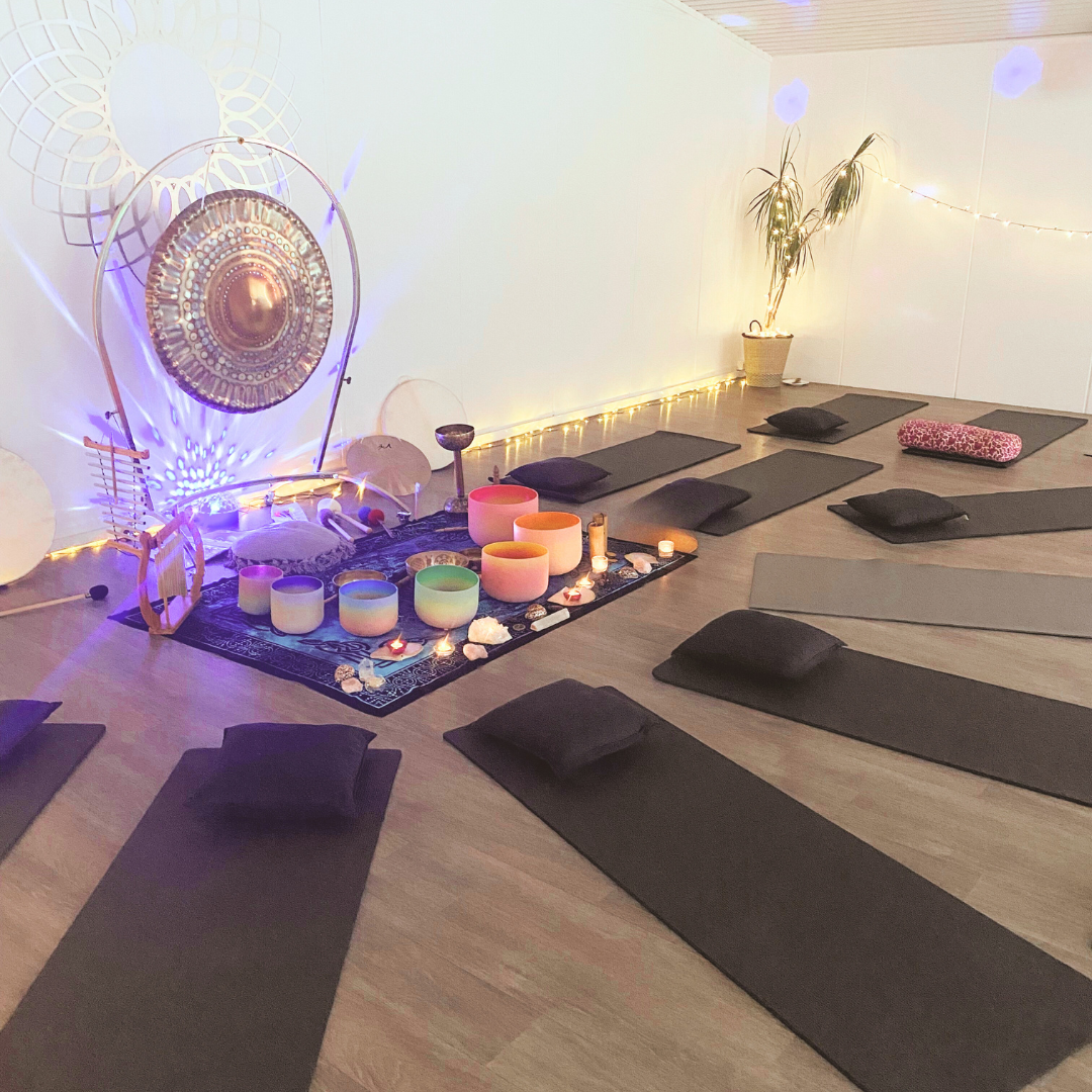A sound bath set up with instruments and yoga mats.