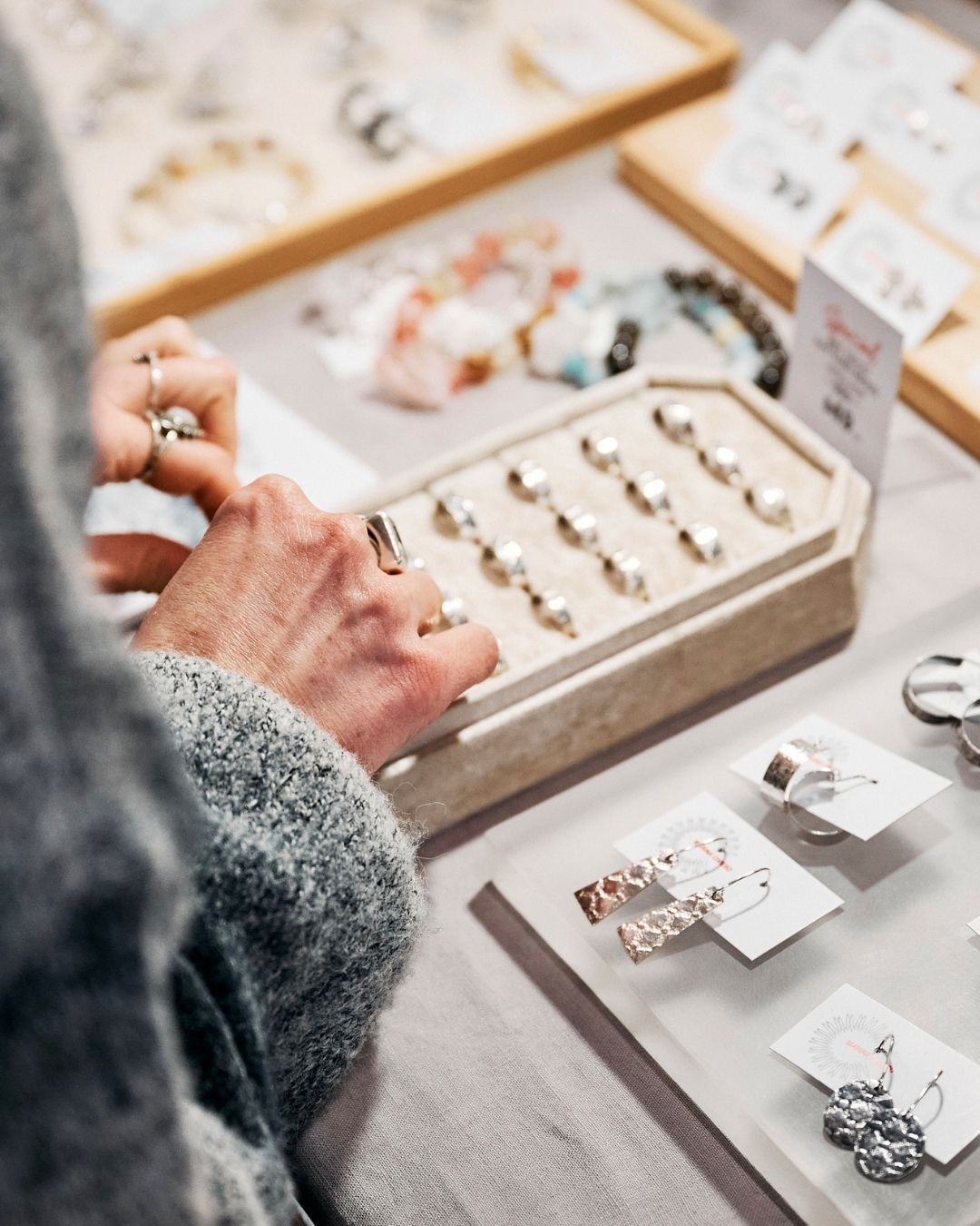 A visitor exploring the creative work from stallholder Marina Civiero @marinaciviero at the Sydney Artisans market