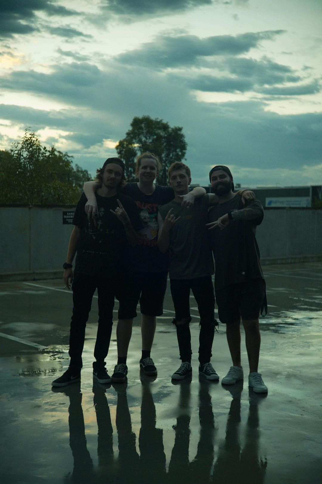 Four band members smiling at camera