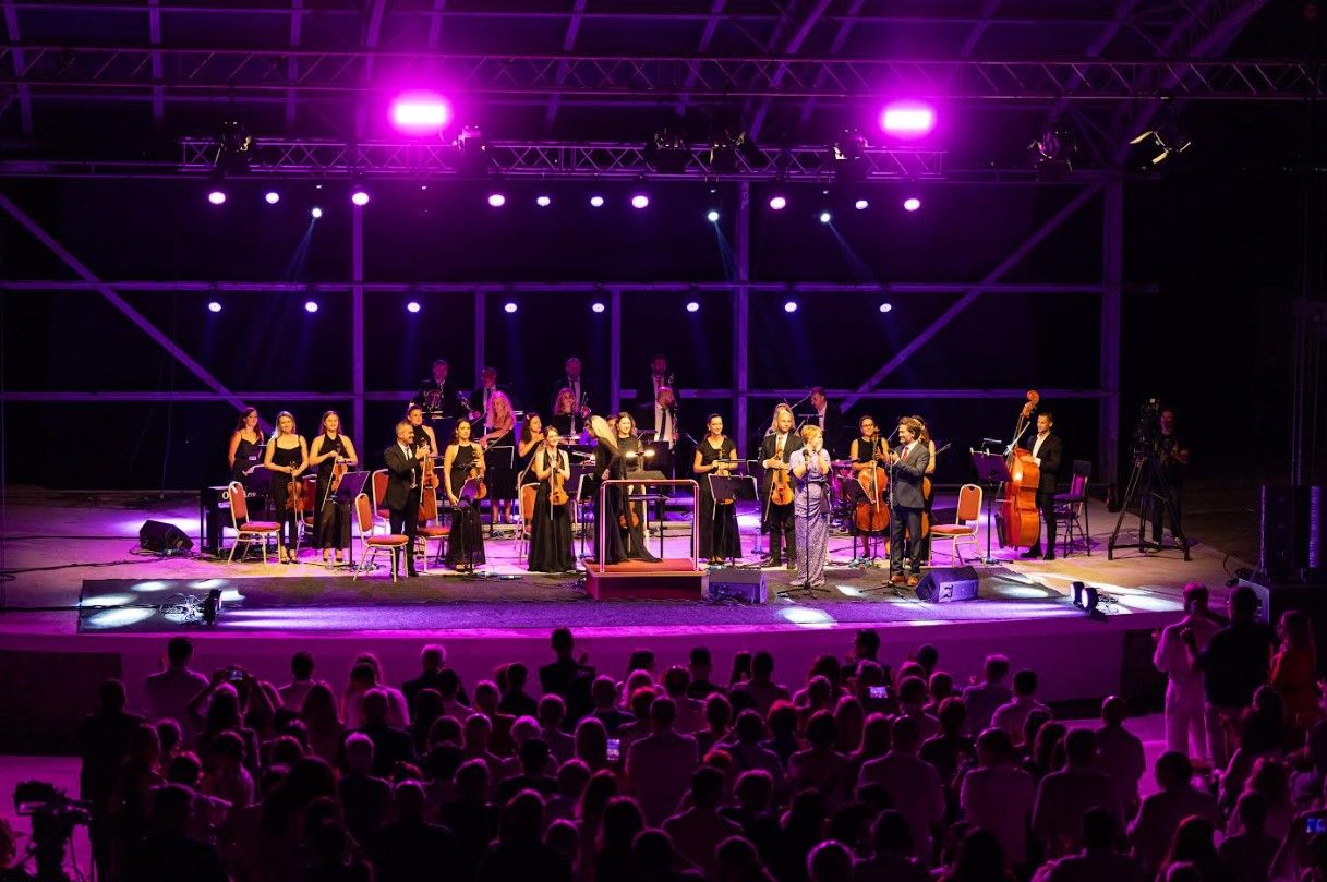 AYGA Symphony Orchestra performing on stage at Ohrid Summer Festival with a large audience at night.