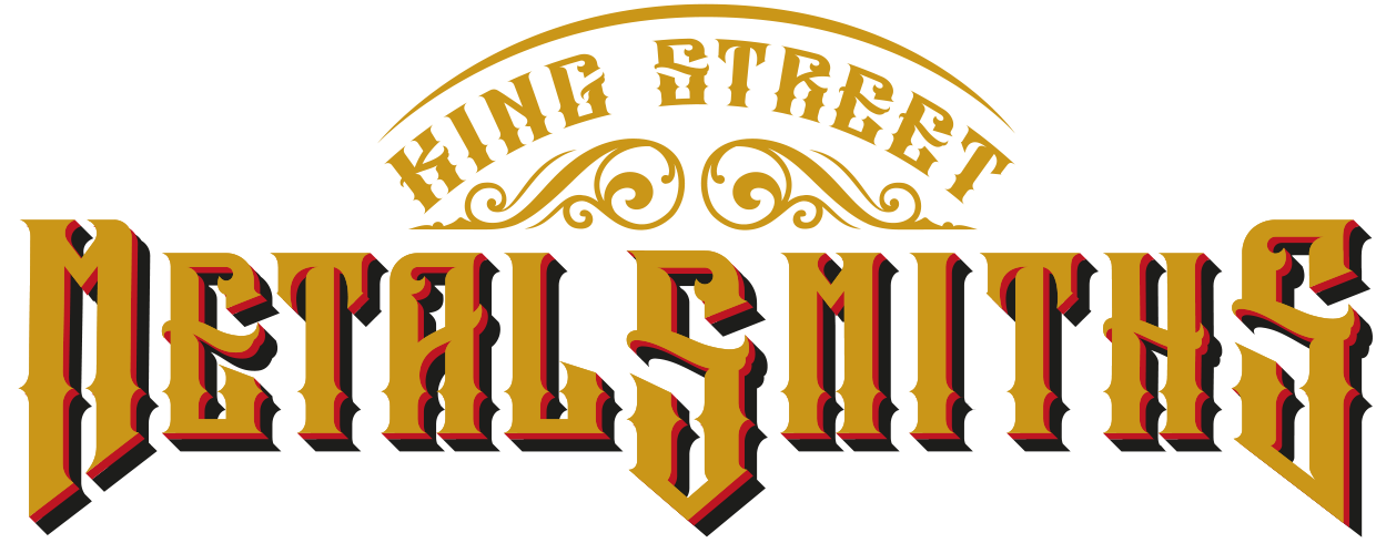 Vintage-style logo with the text "King Street Metalsmiths" in ornate gold and black lettering with decorative swirls.