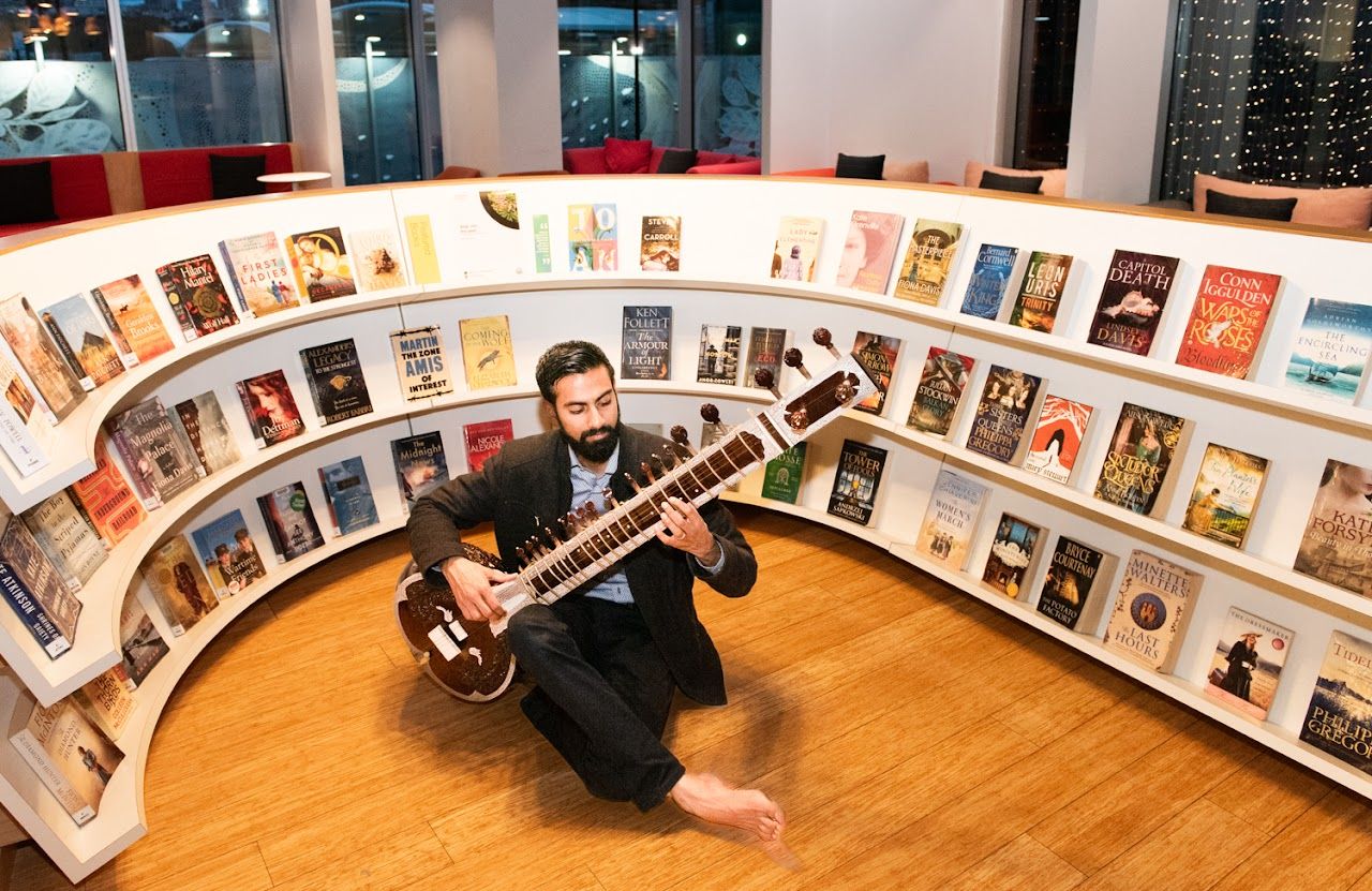 Ravi playing sitar in the library