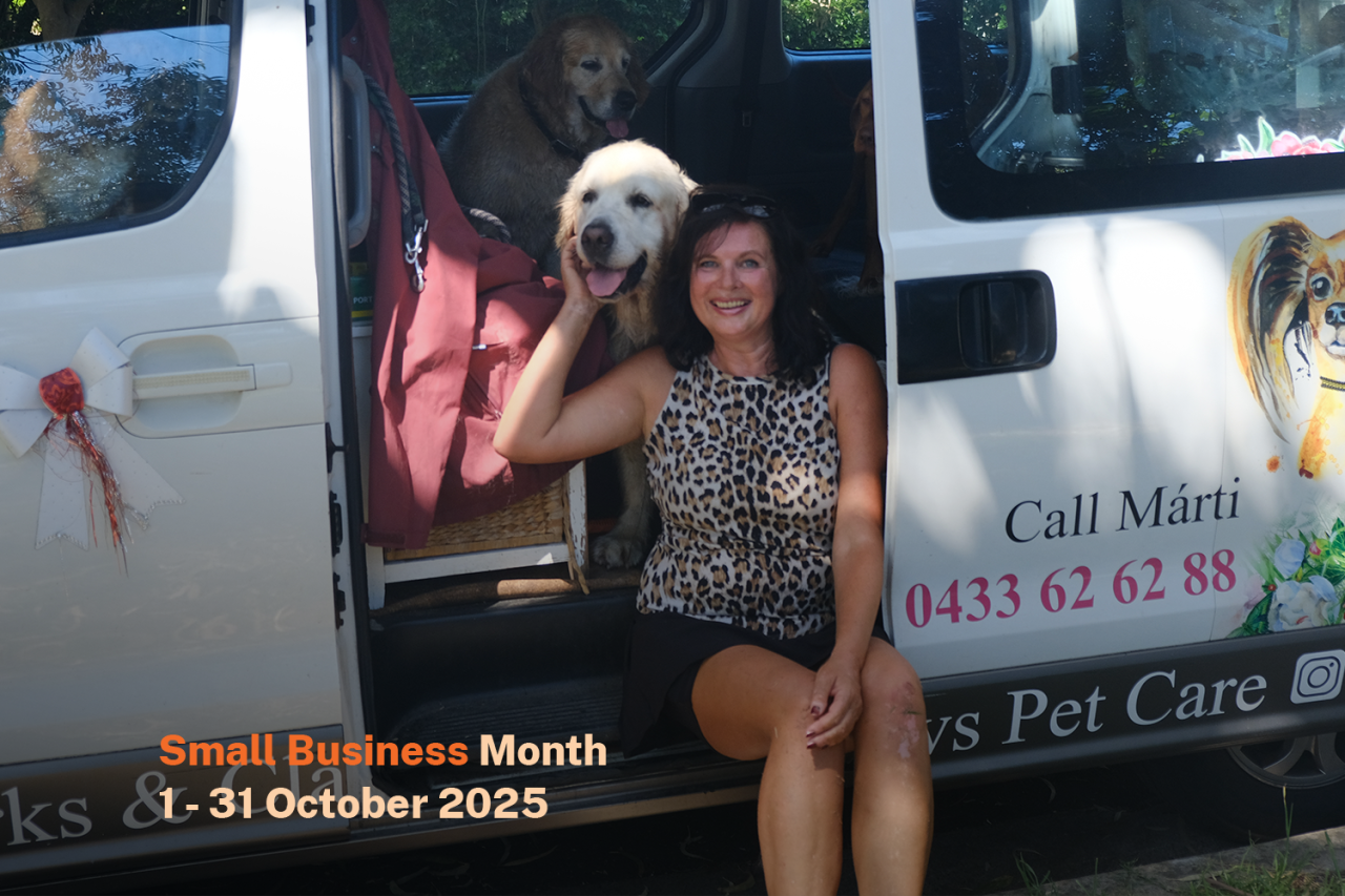 Woman sitting with a dog in a van decorated for pet care, with "Small Business Month 1-31 October 2025" text overlay.