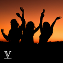 Silhouette's of people facing a sunset