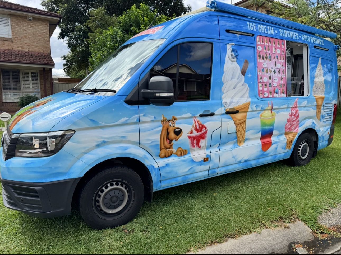 Ice cream van serving soft serve, milkshakes and slushies at an event
