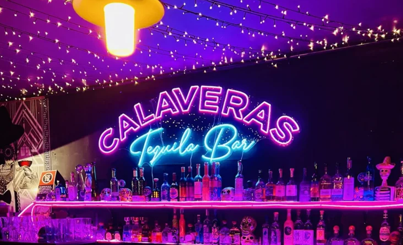 A custom LED neon sign designed and produced by Beyond Neon Signs, mounted on a wall inside a retail or event space with vibrant lighting and a modern visual style.