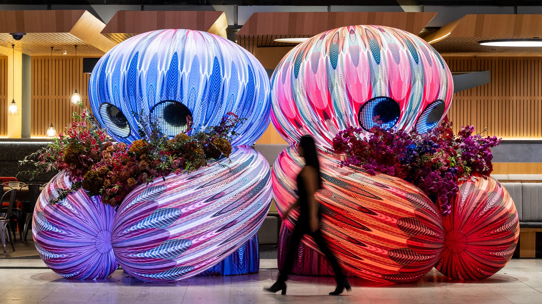 Two inflatable characters holding bunches of flowers