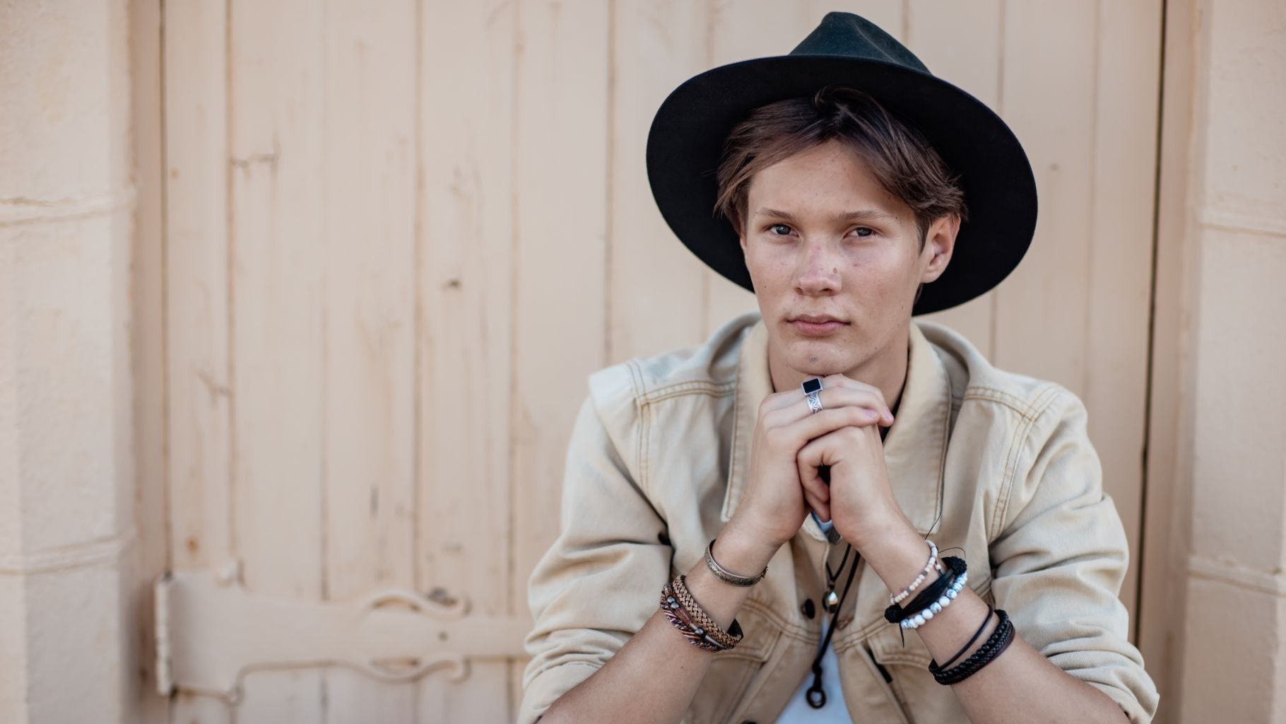 a singer in the foreground with a blurred beige door filling the background