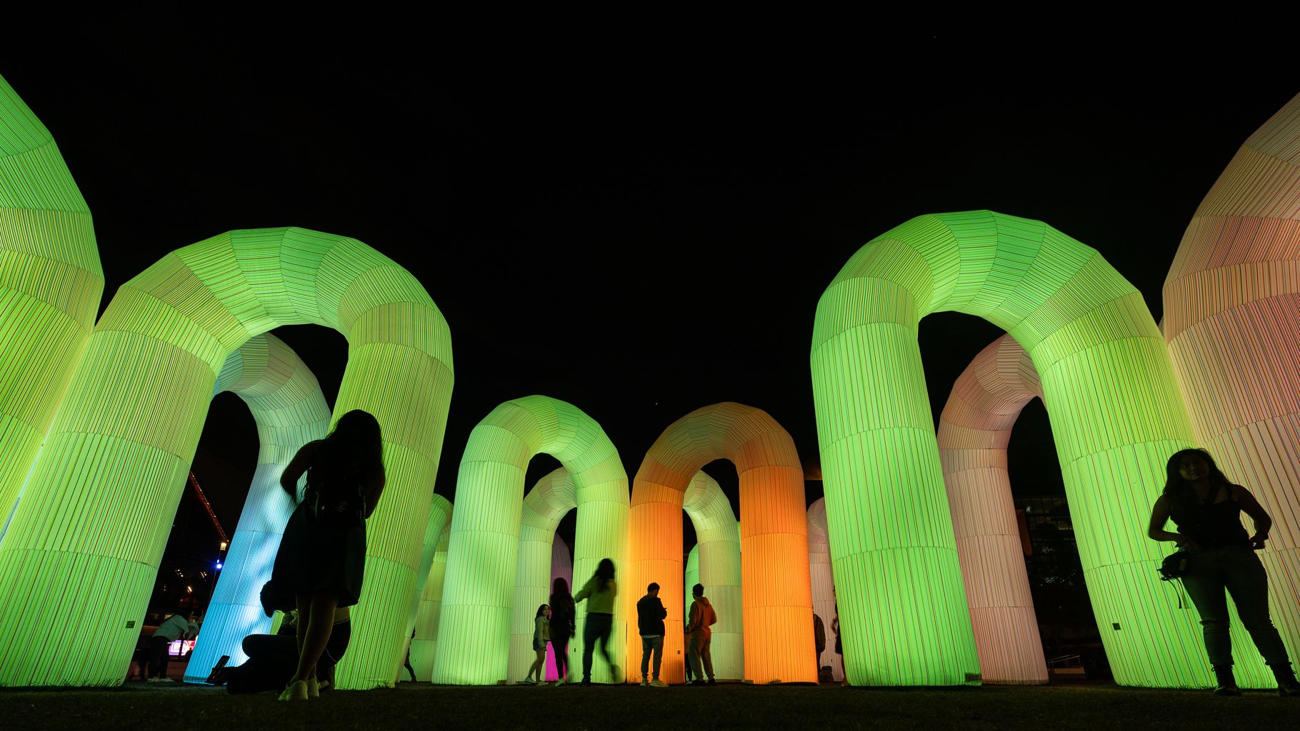 People around an inflatable light installation at Darling Harbour