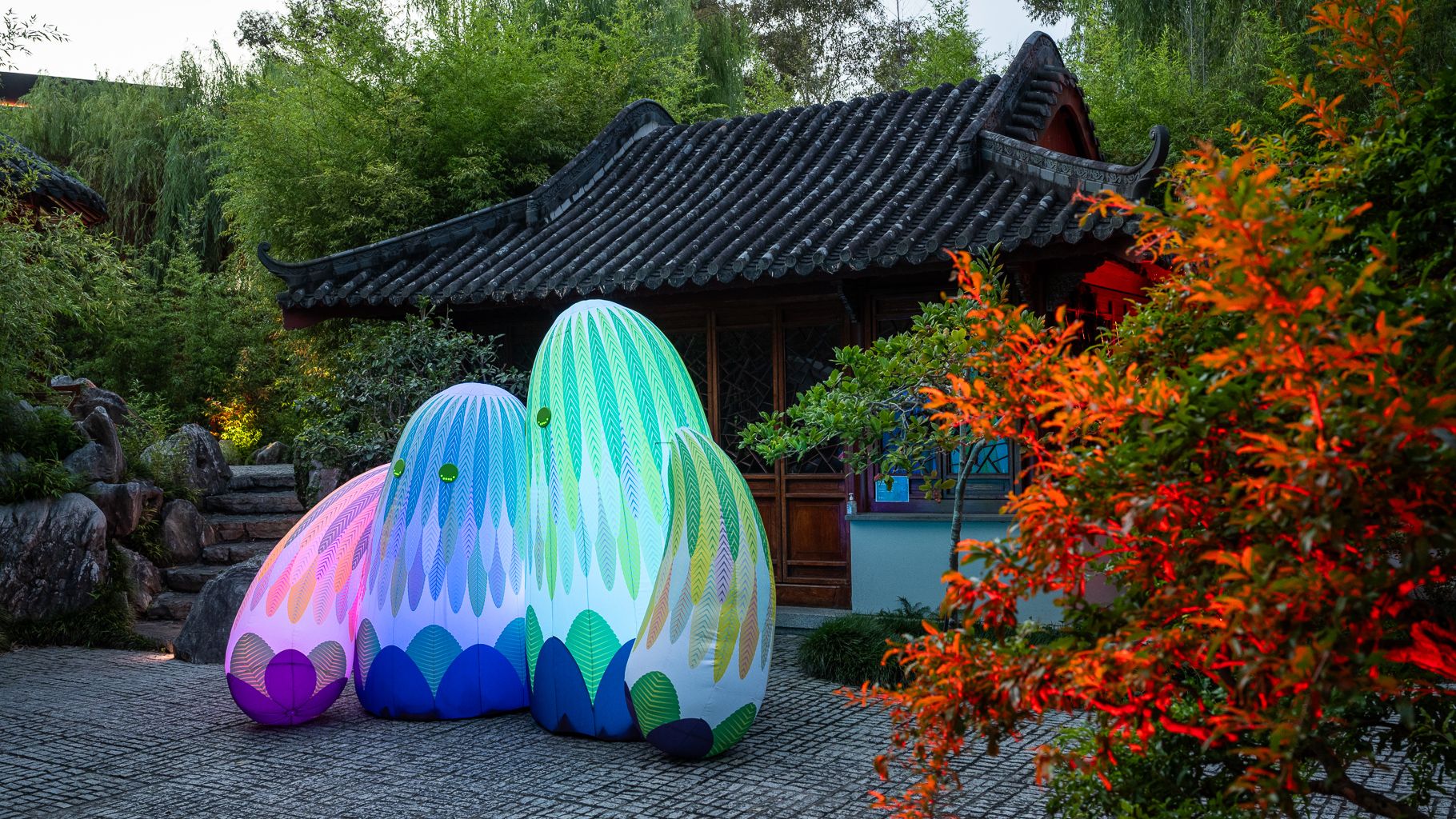 Two inflatable characters hugging in Chinese Garden