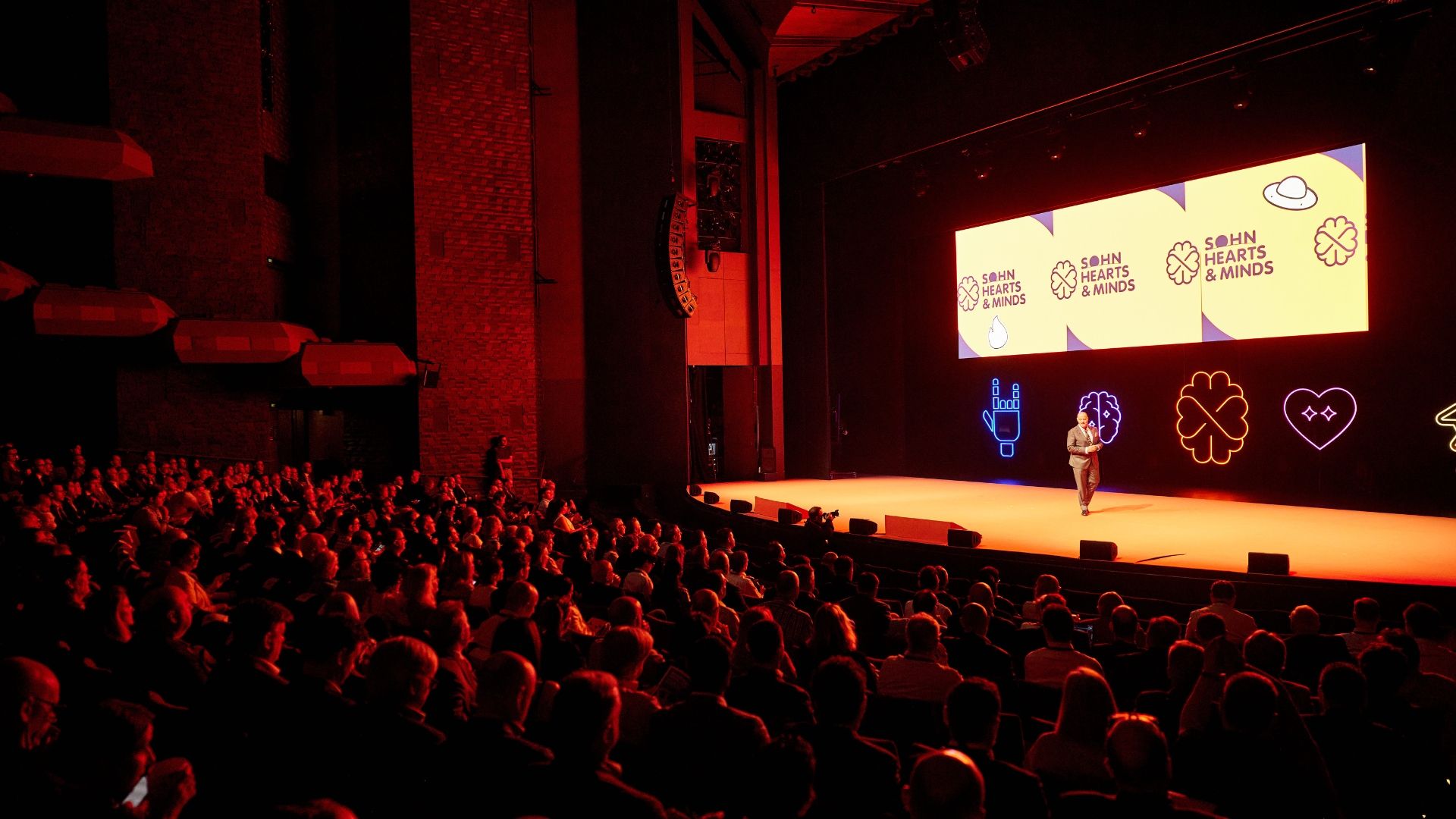 A speaker on stage at a conference