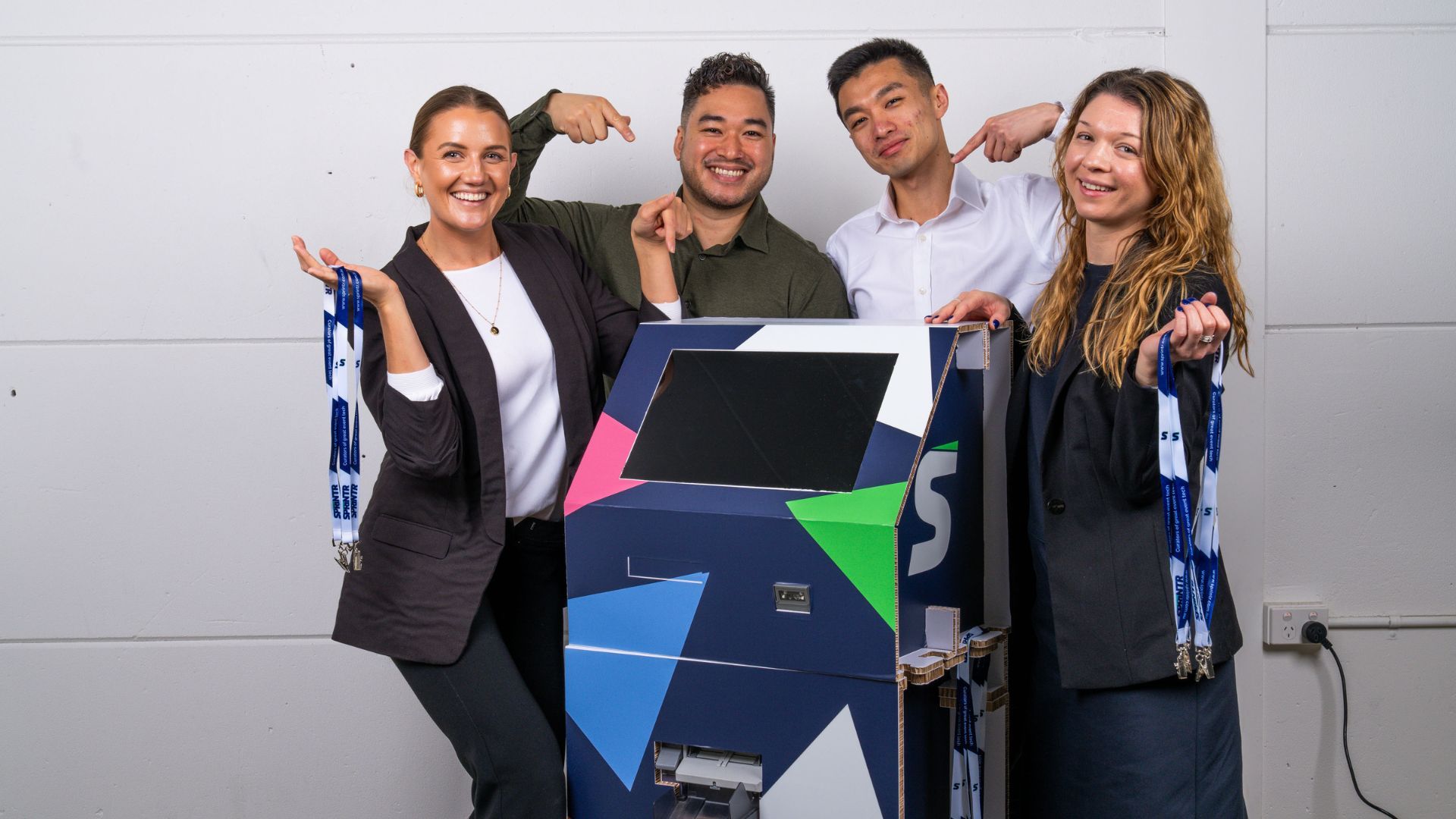 The Sprintr team with an Ecokiosk and event lanyards