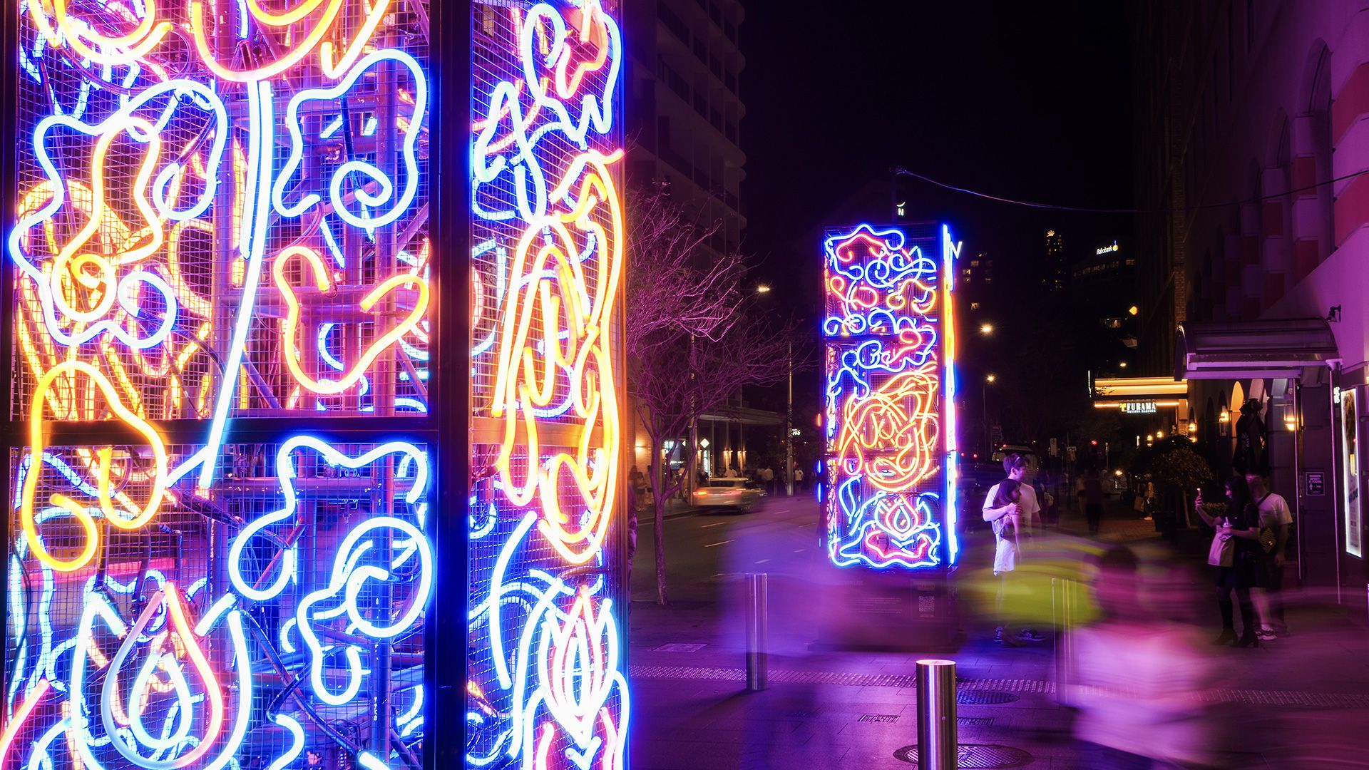 Two bright neon lighting towers in Asian designs