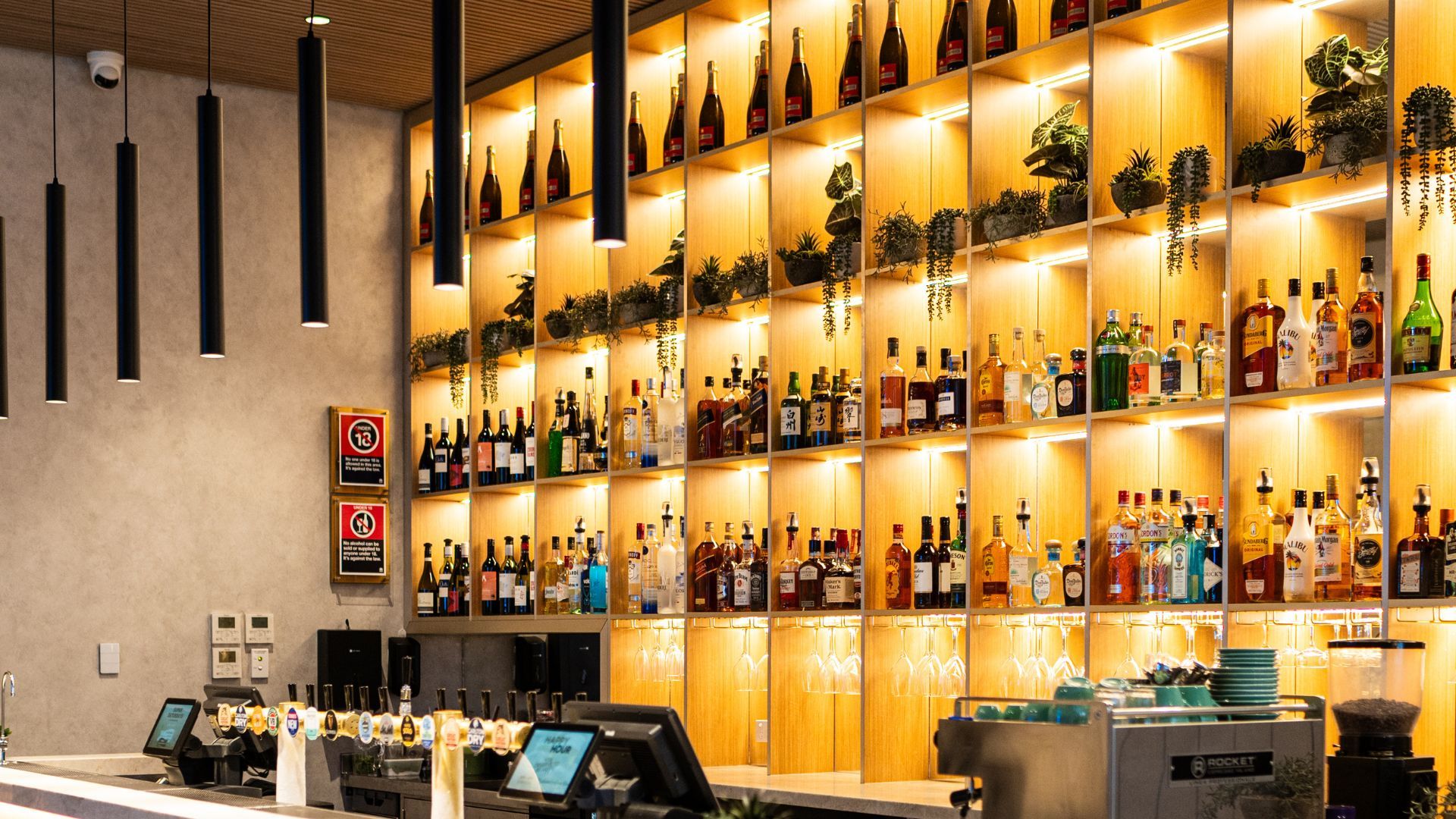 bar at the hospitality venue, gold and bright shelving behind