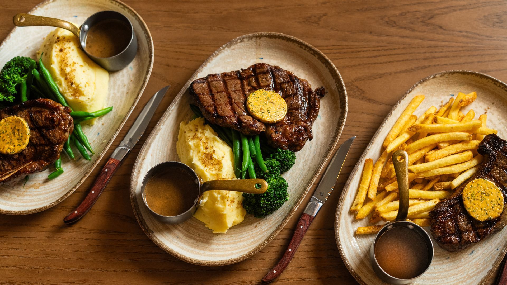 three plates of steak on a table