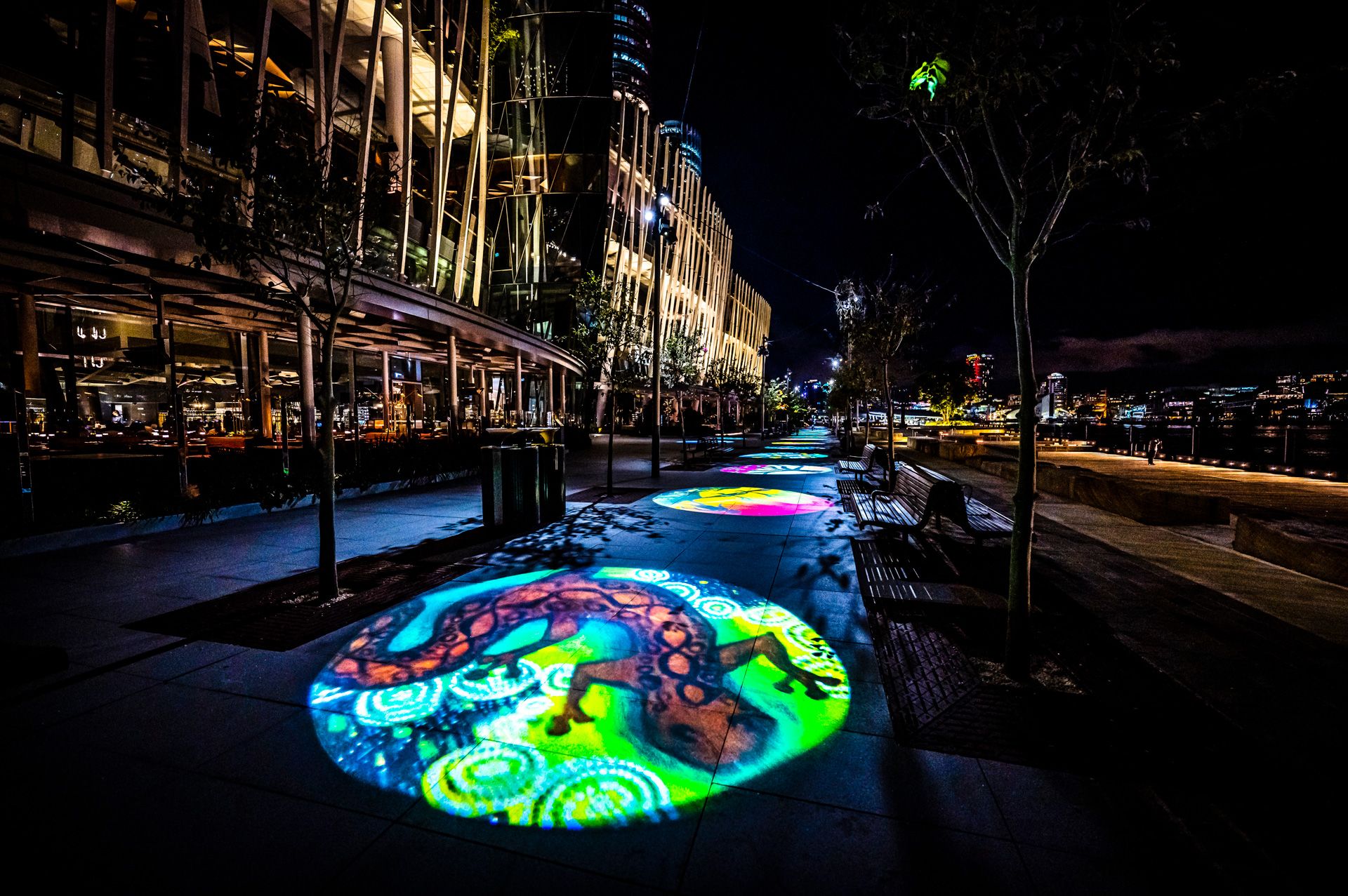 Projected imagery of individually created artworks along a harbourfront walk