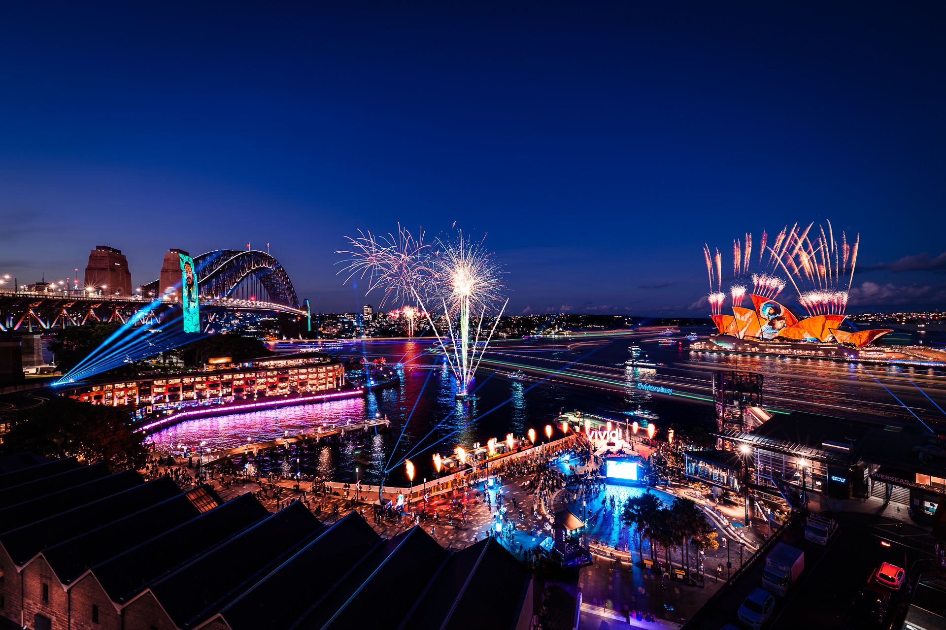 A large crowd at Circular Quay watching the fireworks above the Sydney Opera House and Sydney Harbour Bridge during the opening night of Vivid Sydney.