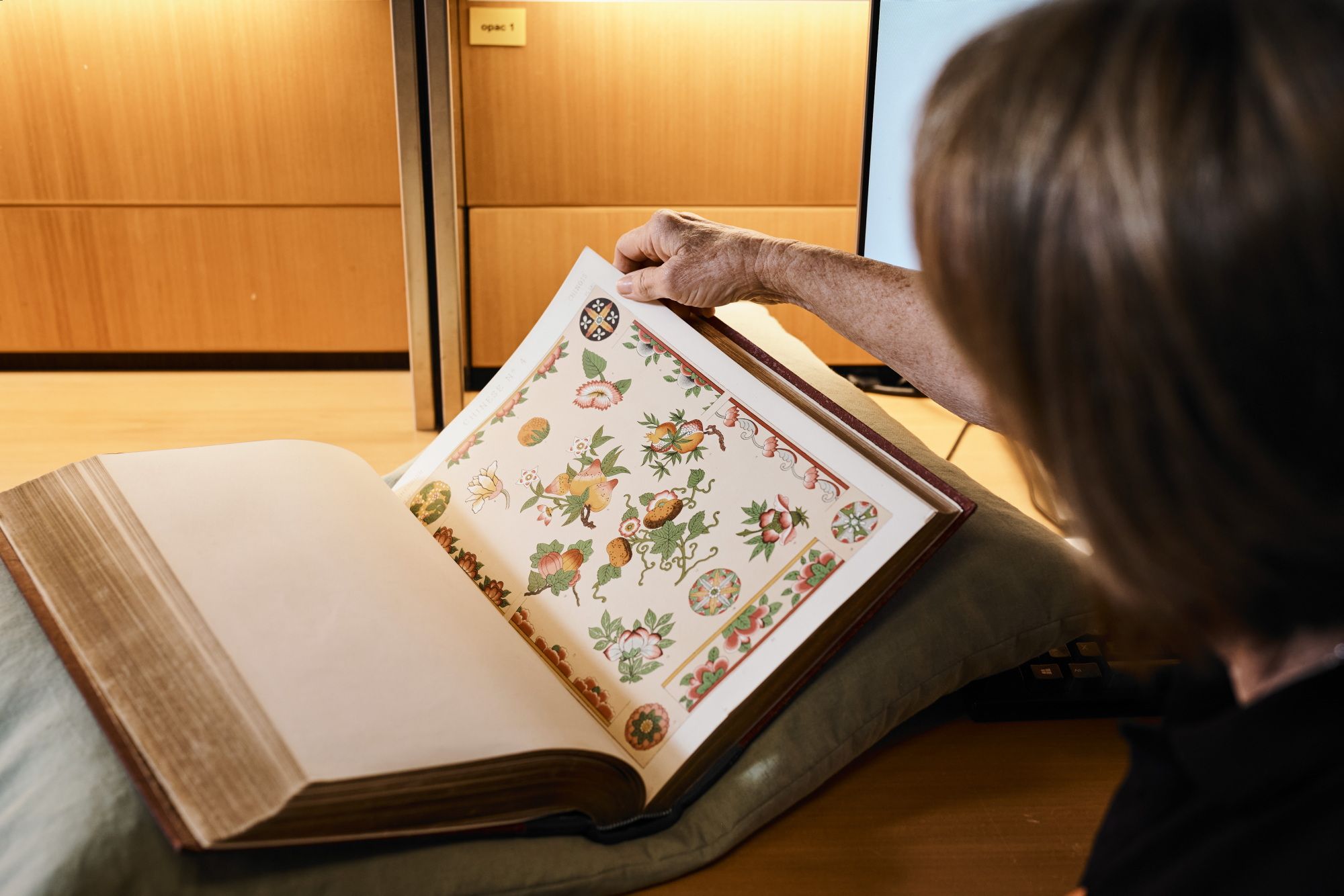 Visitor looking through pattern book