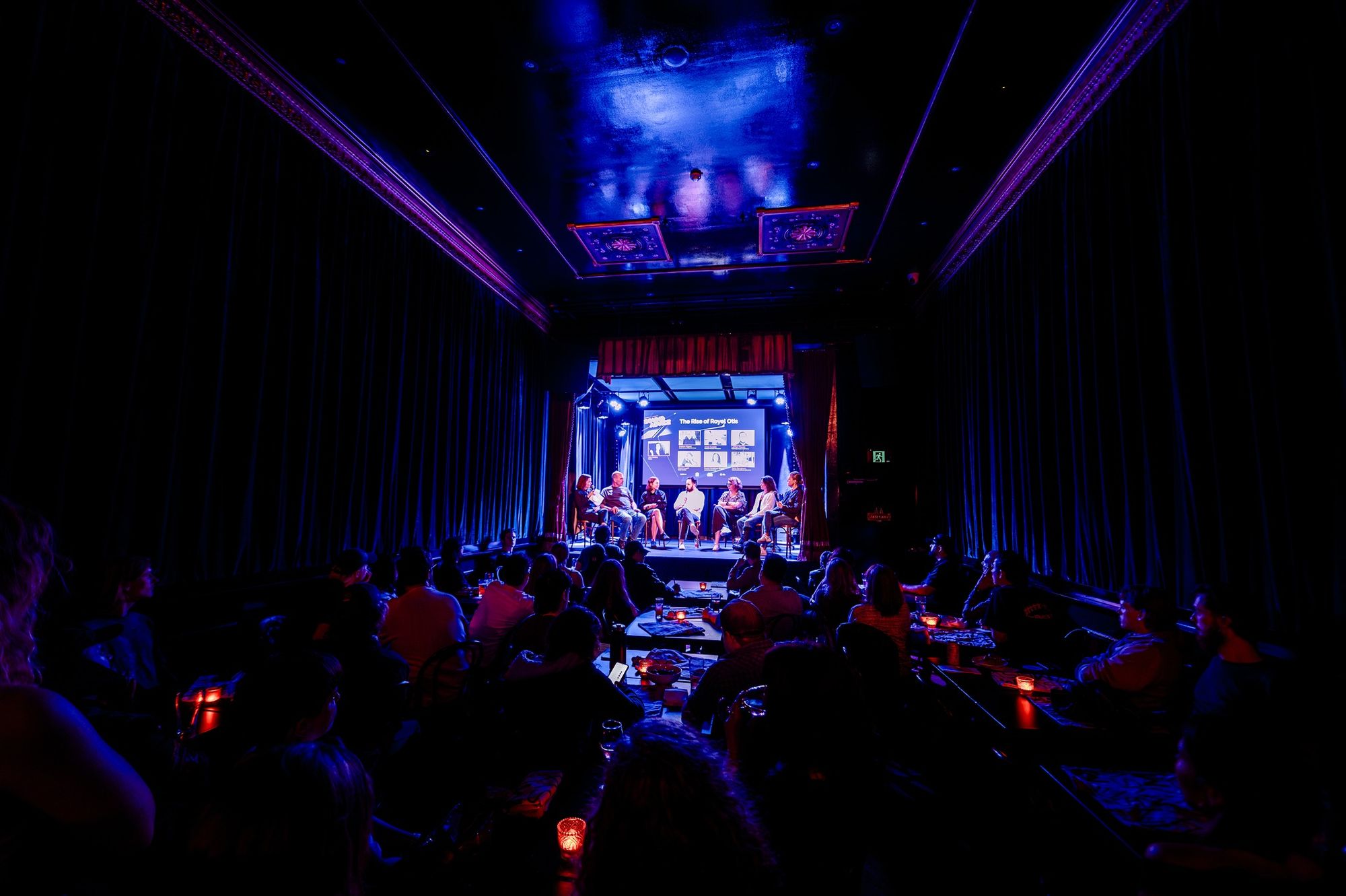 A panel discussion hosted in a moody music venue