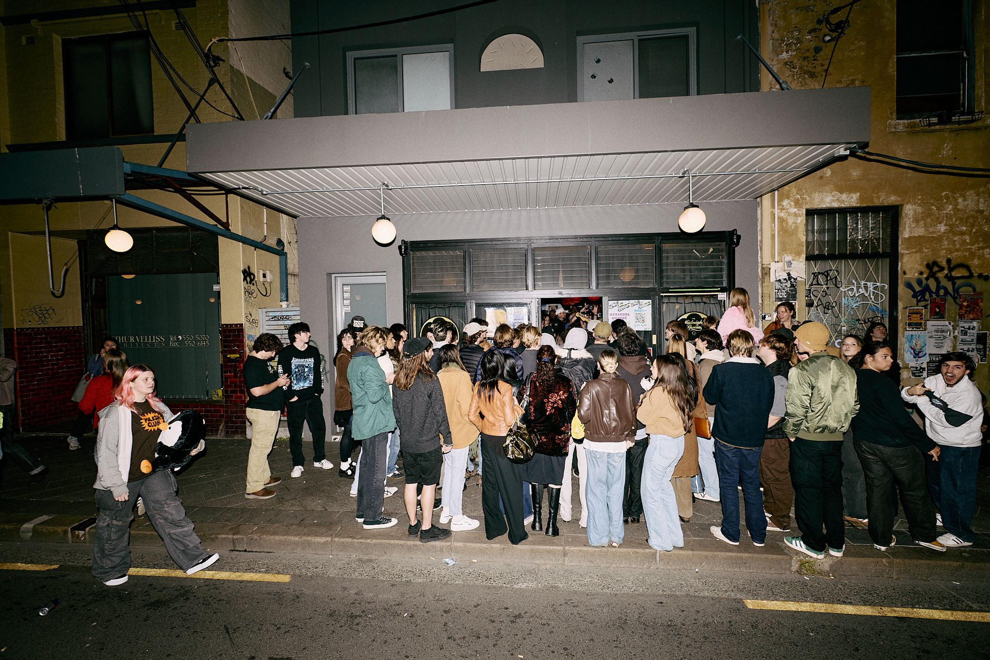 People spewing onto the street from a busy Midnight Specail