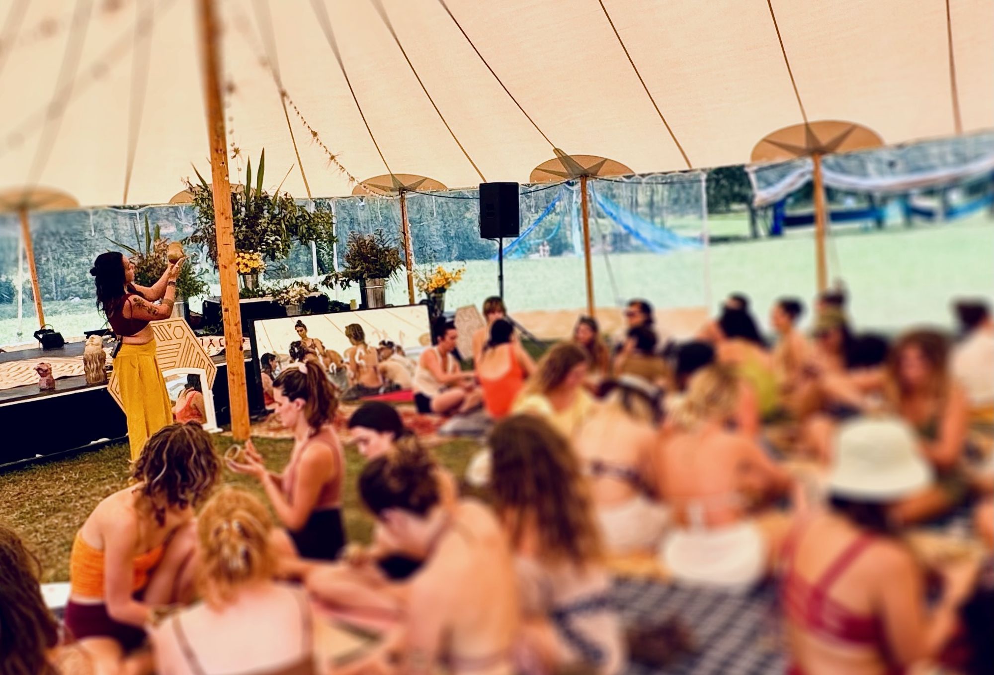 Manuela teaching to a large crowd of women at Ember Collaborative Gathering
