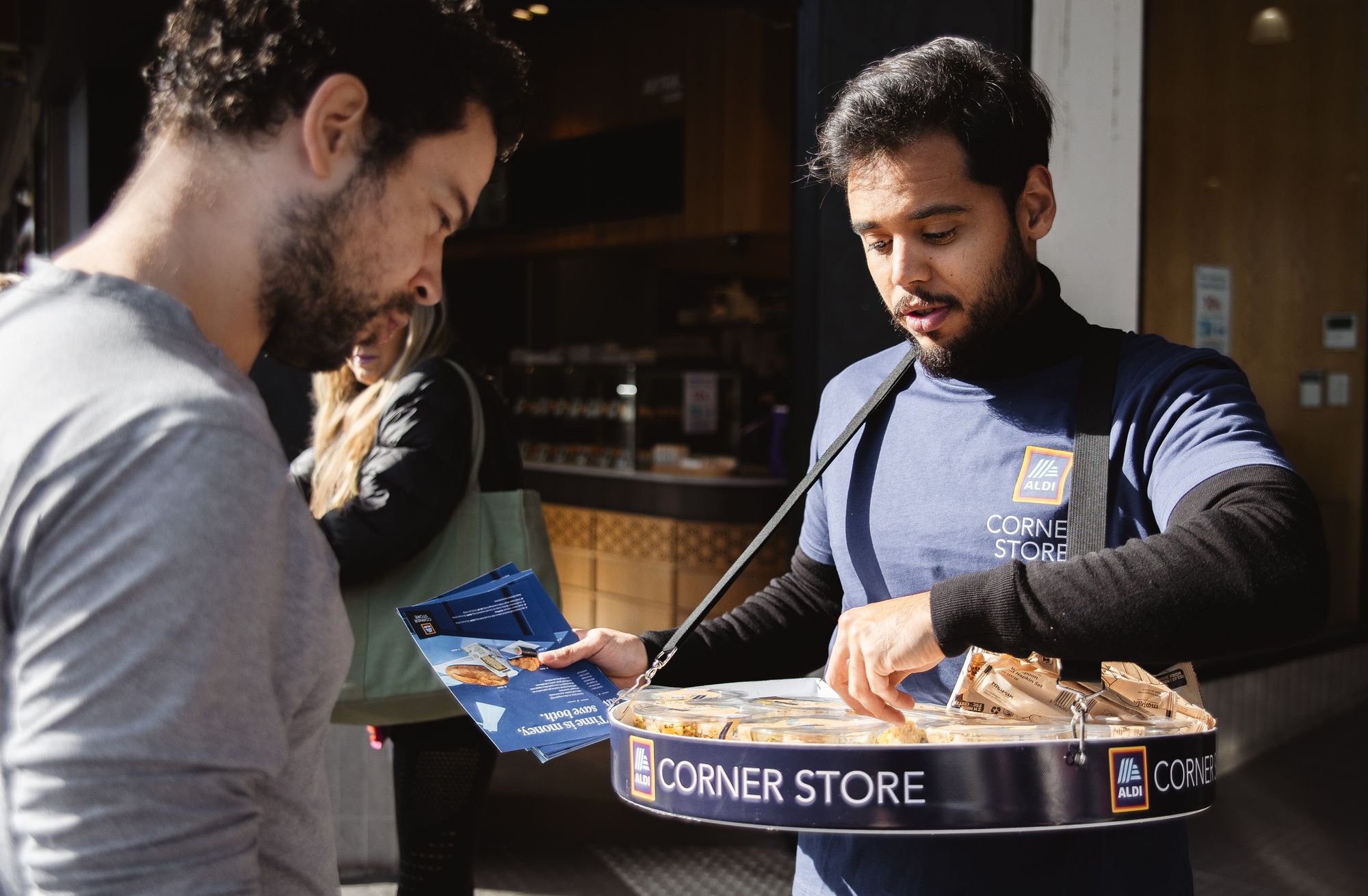 Person holding a tray of sandwiches