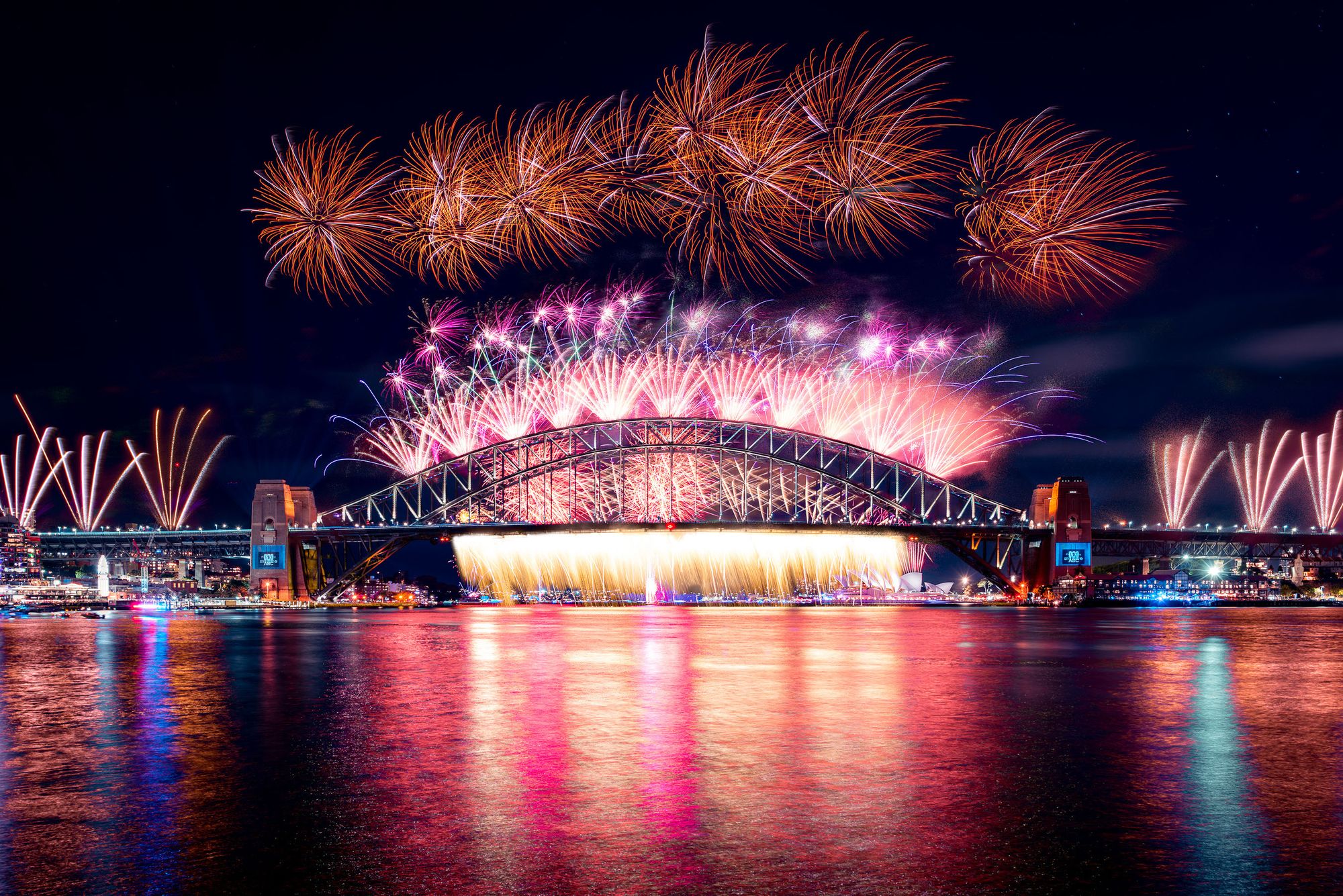 New Year's Eve fireworks above the Sydney Harbour Bridge, with the Sydney Opera House in the background as viewed from Blues Point.
