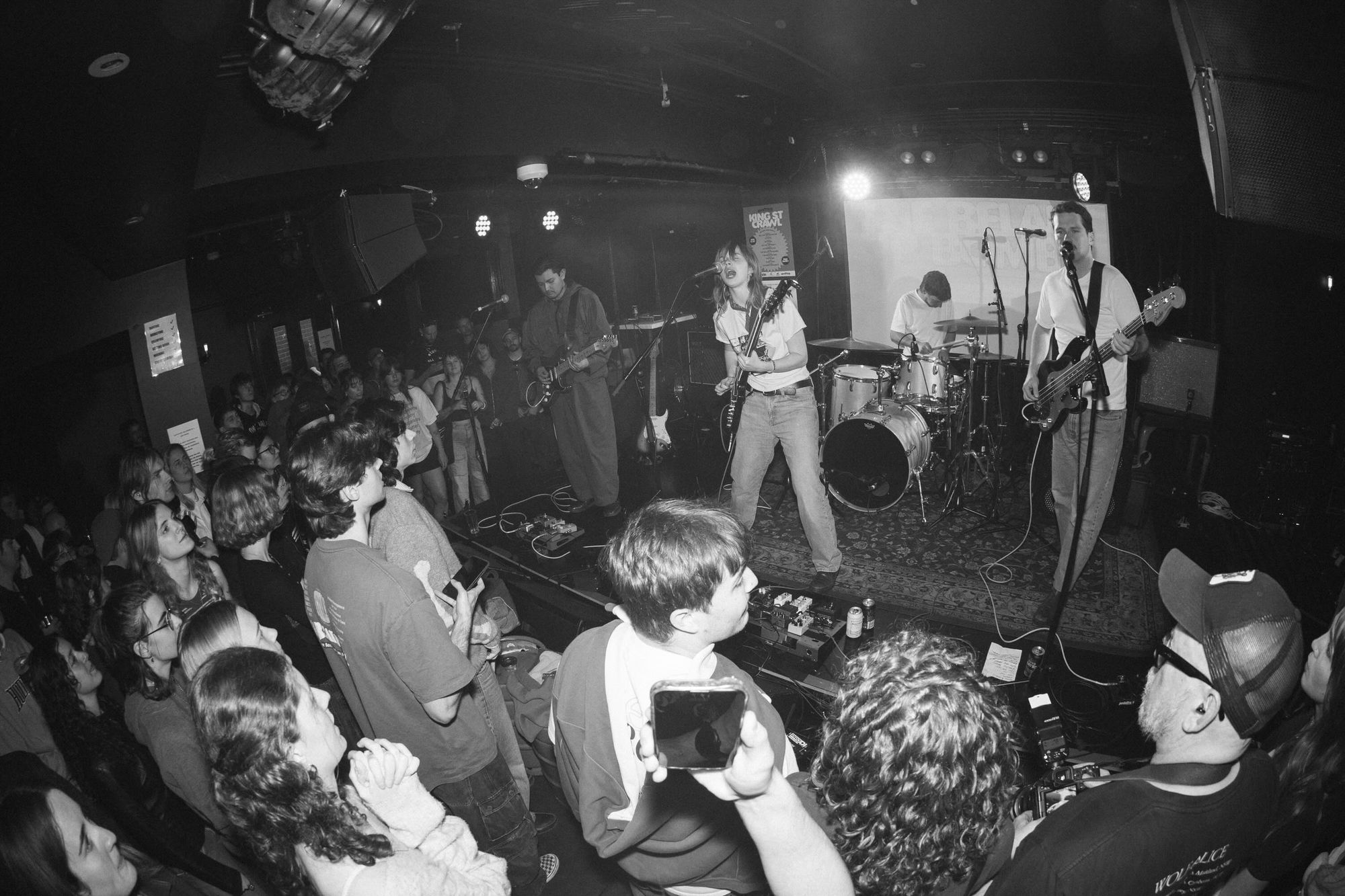 4 Pieces Band called Belair Lip Bombs, Girl Lead Singer and three Boys, playing on a riased stage at Waywards Ballroom at King Street Crawll