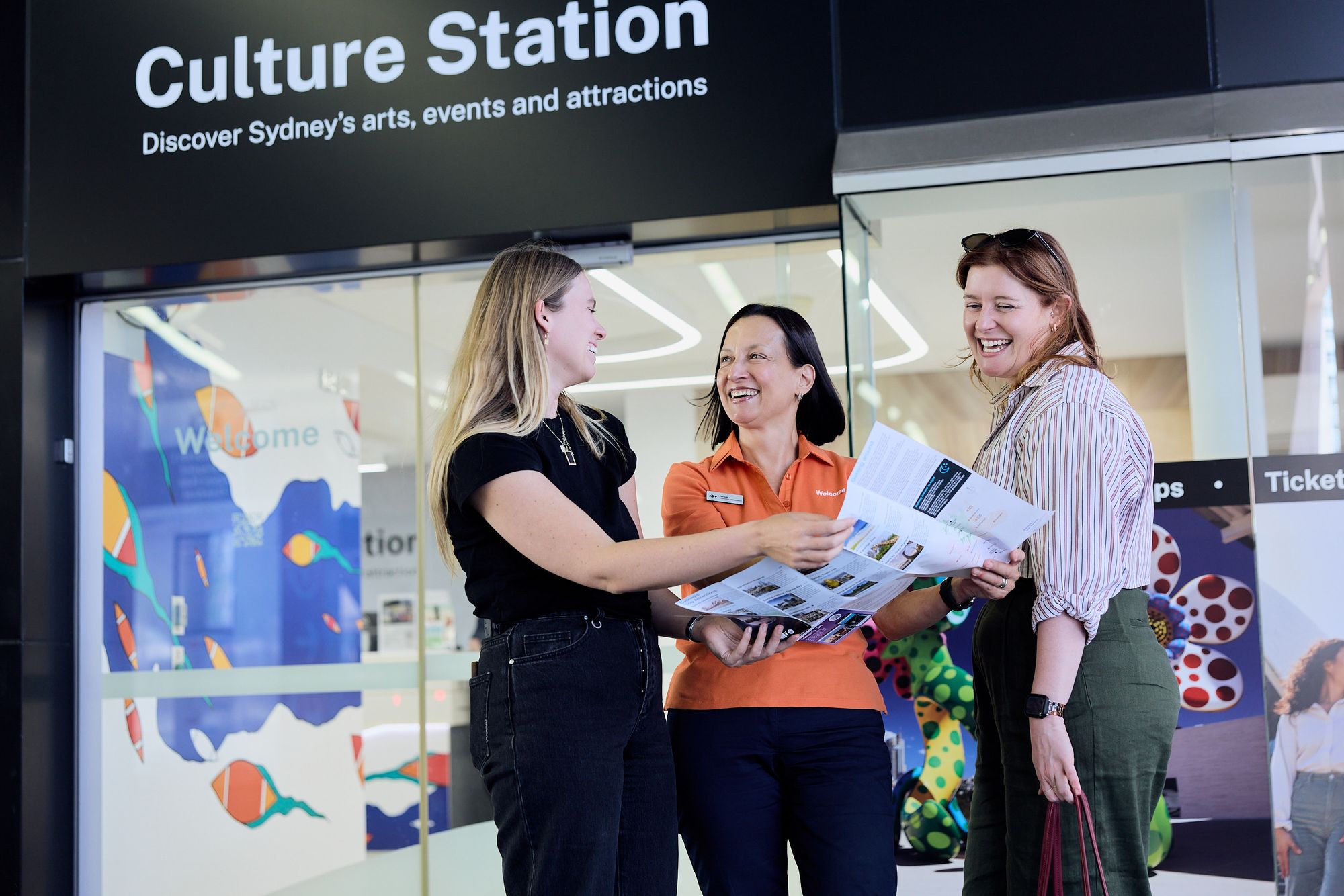 Two people receiving assistance reviewing a map.