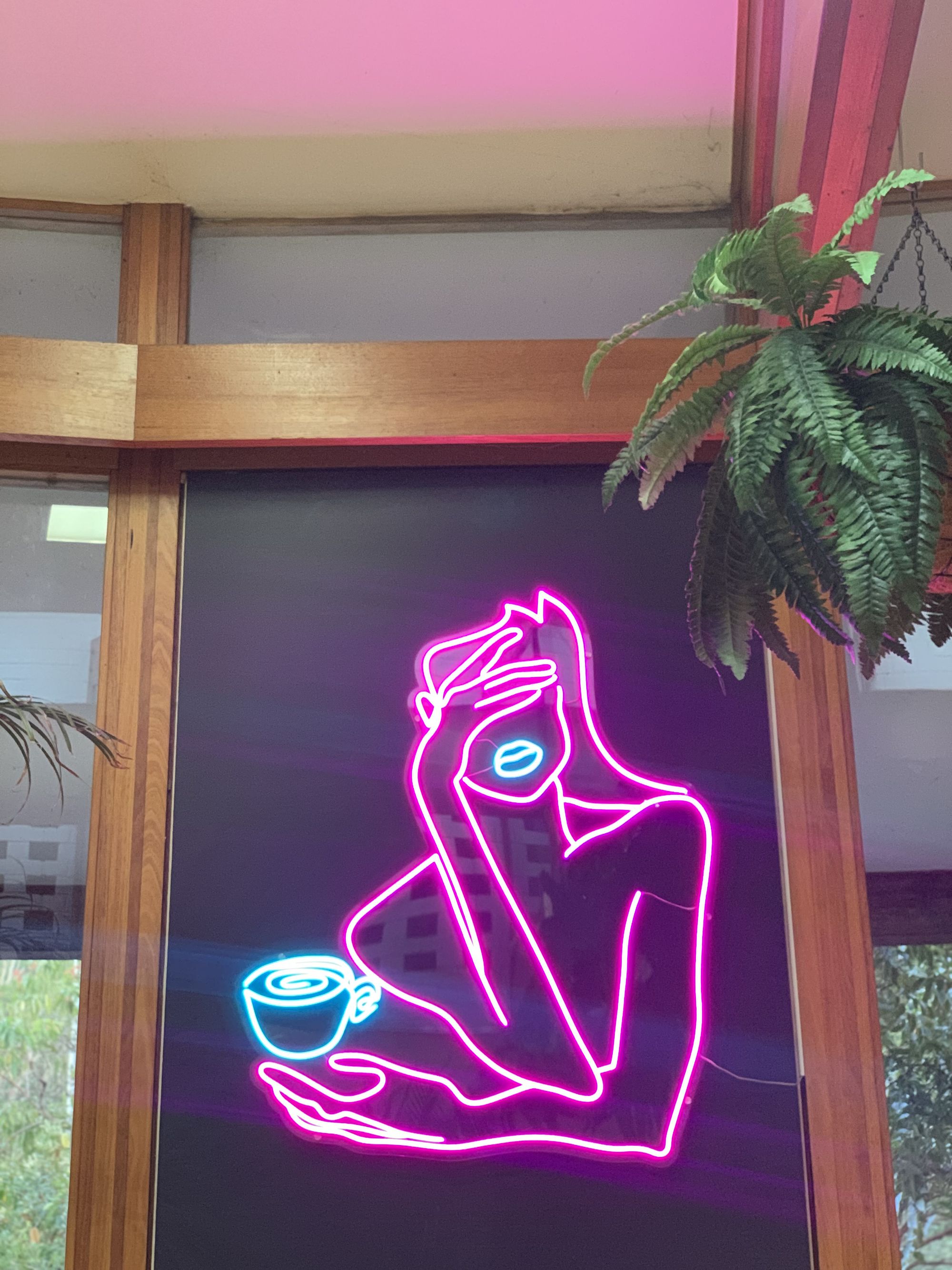 Custom neon art glowing bright and adding a modern café vibe.