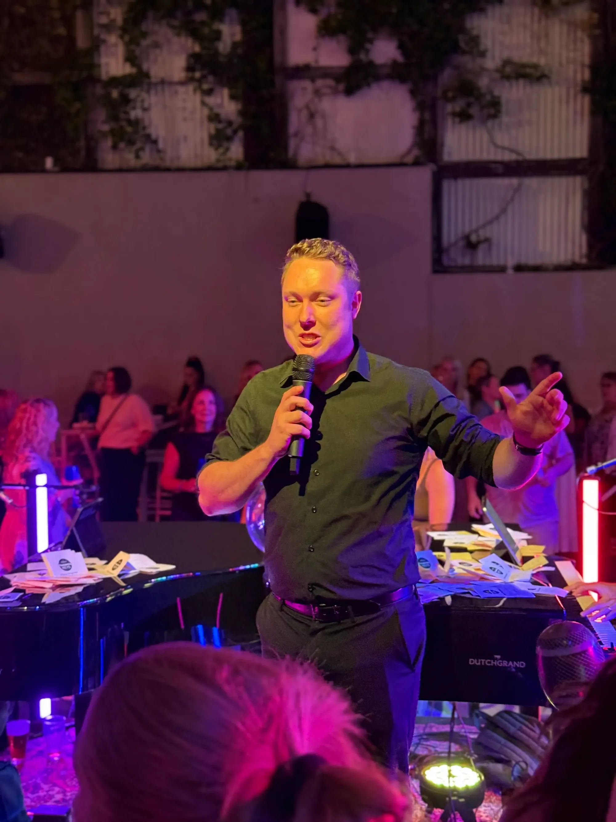 Blake from The Curiosity Spark hosting an event with a microphone