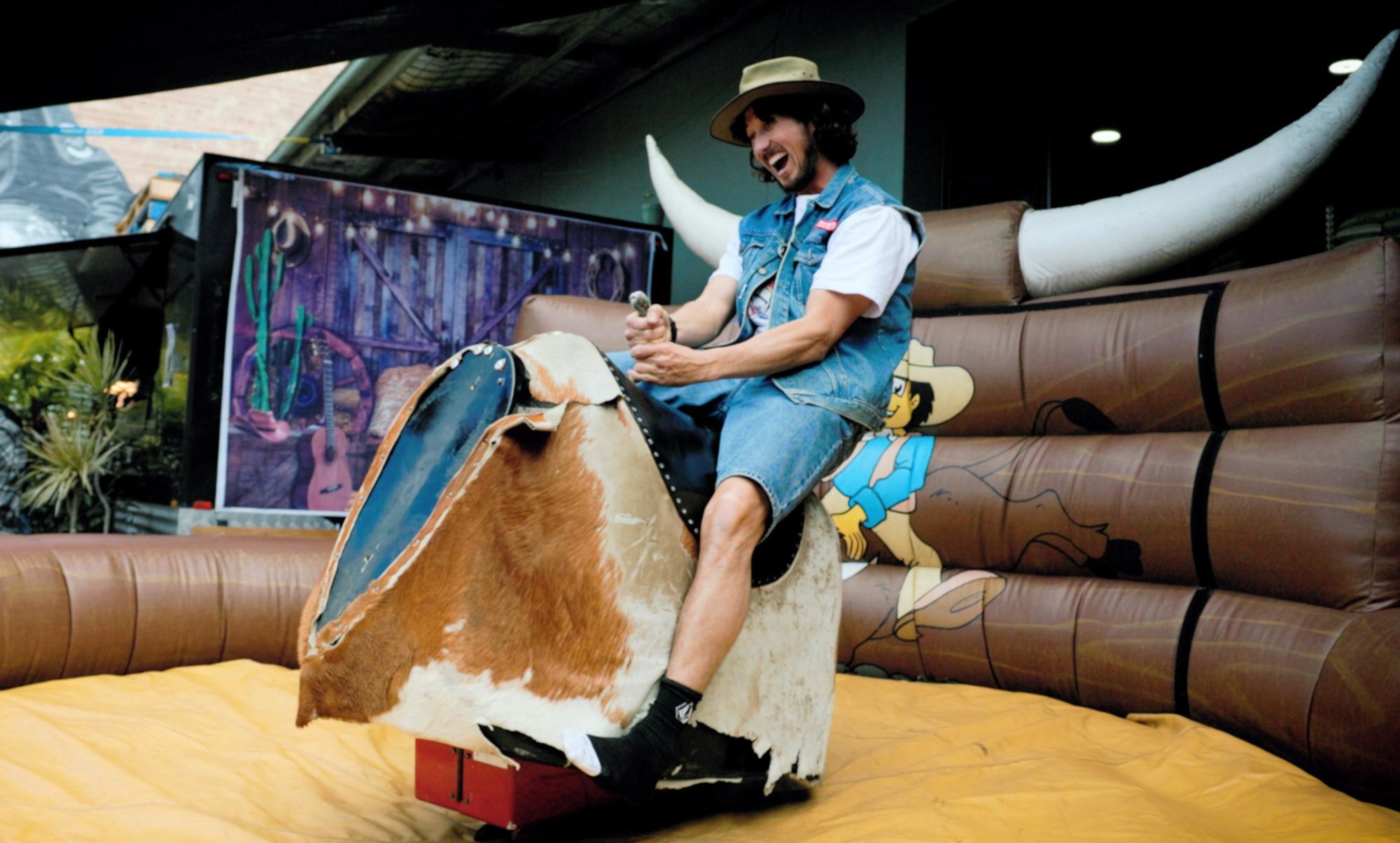 Mechanical bull rider enjoying the ride.