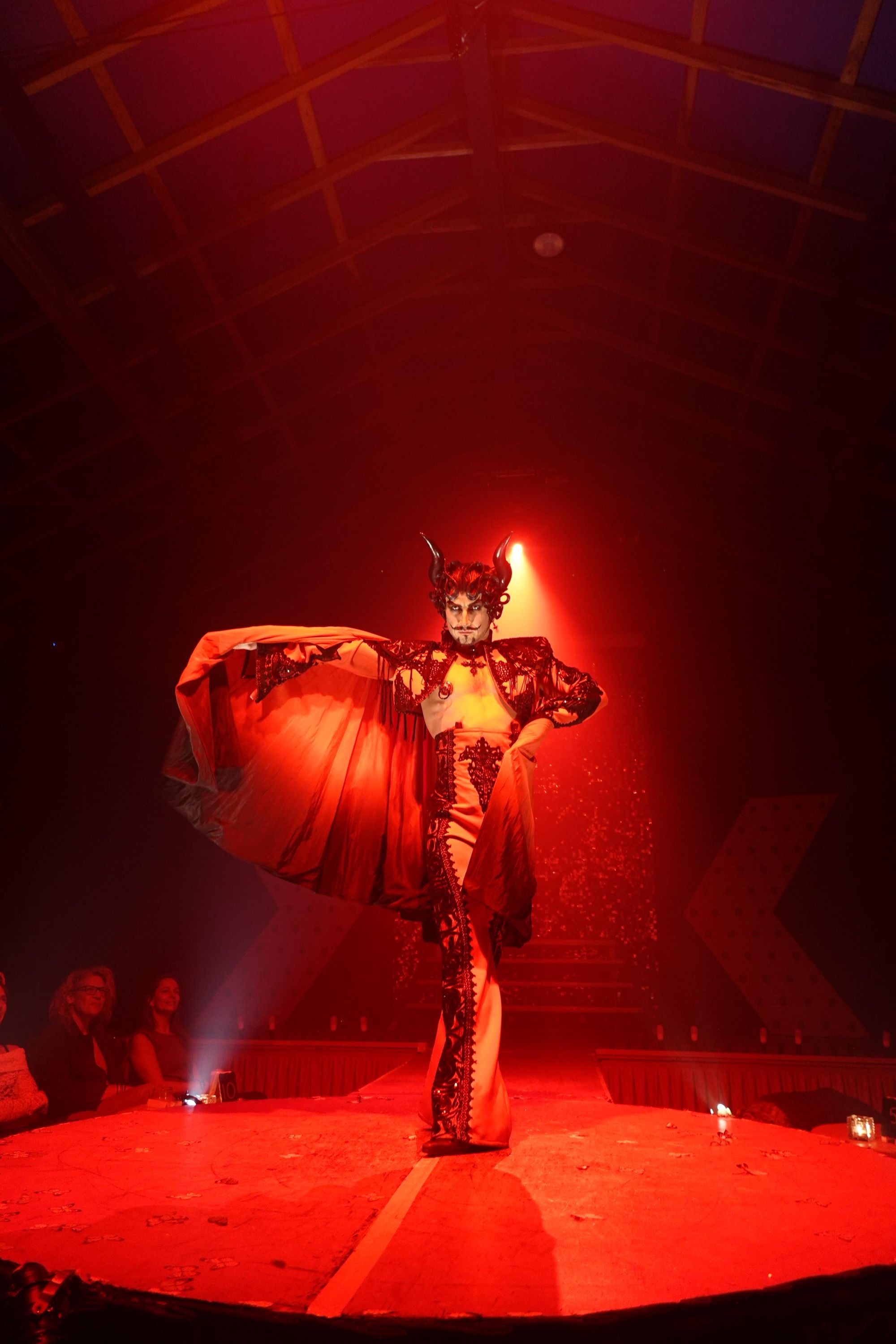 Rhys sets the mood onstage wearing a dramatic red and black matador style costume with devil horns and cape