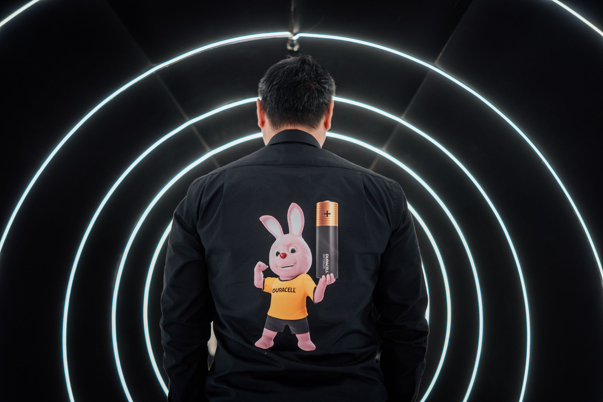 Man standing in a tunnel of lights