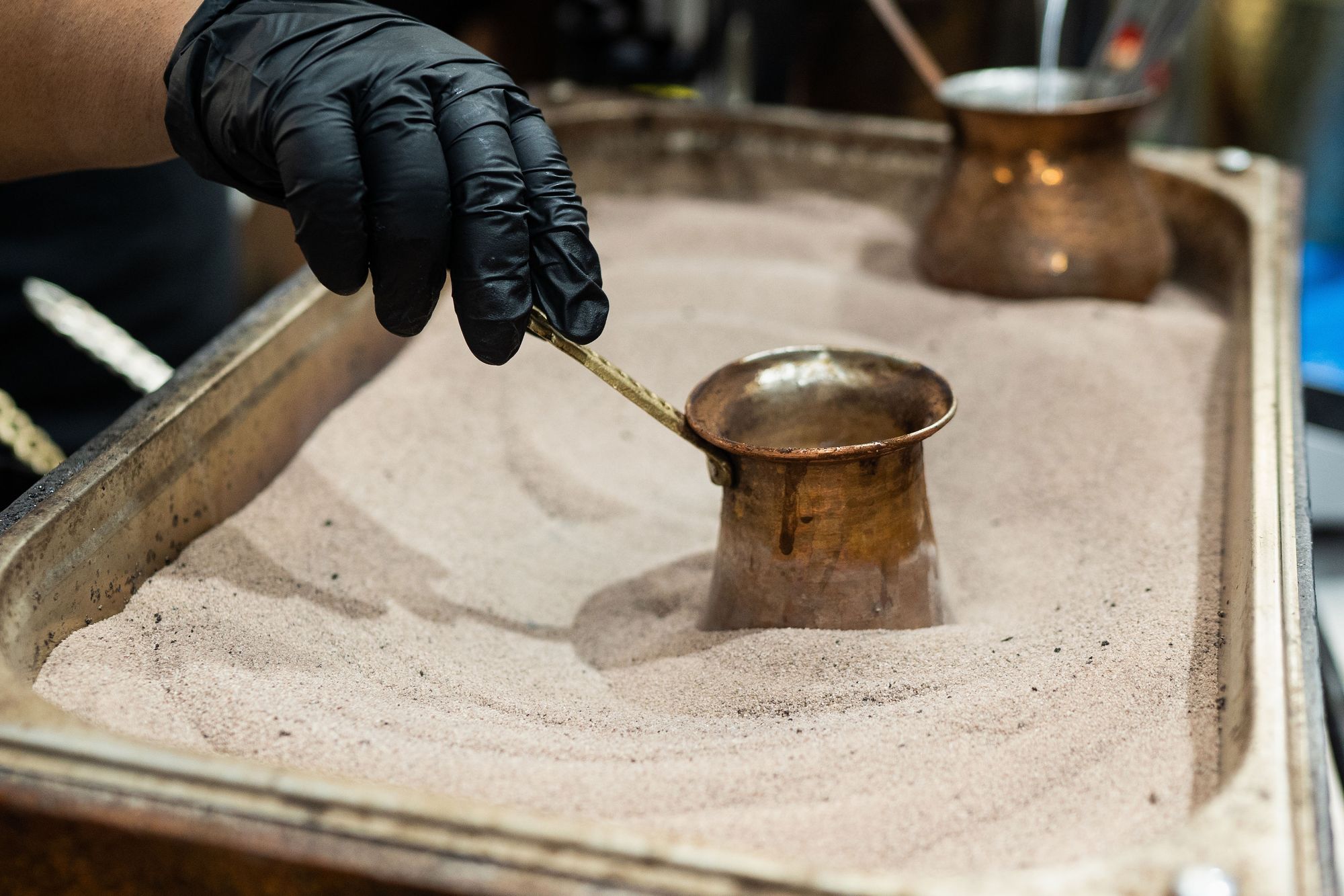 Arabic coffee is kept warm at a stall