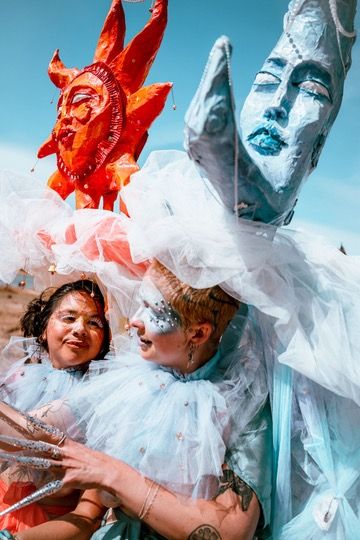 Two performers wearing our gorgeous Sun and Moon Costumes at Dragon Dreaming Festival