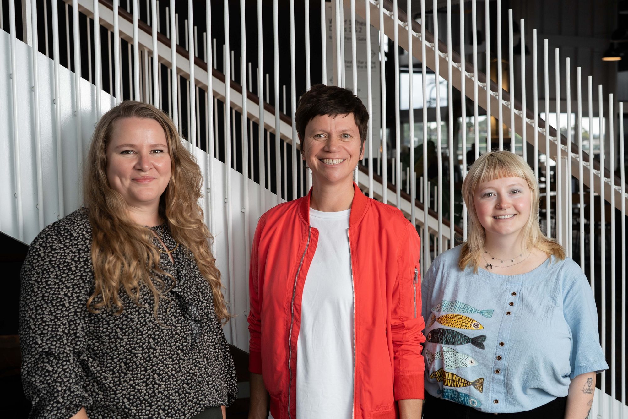 Three people smiling at the camera.