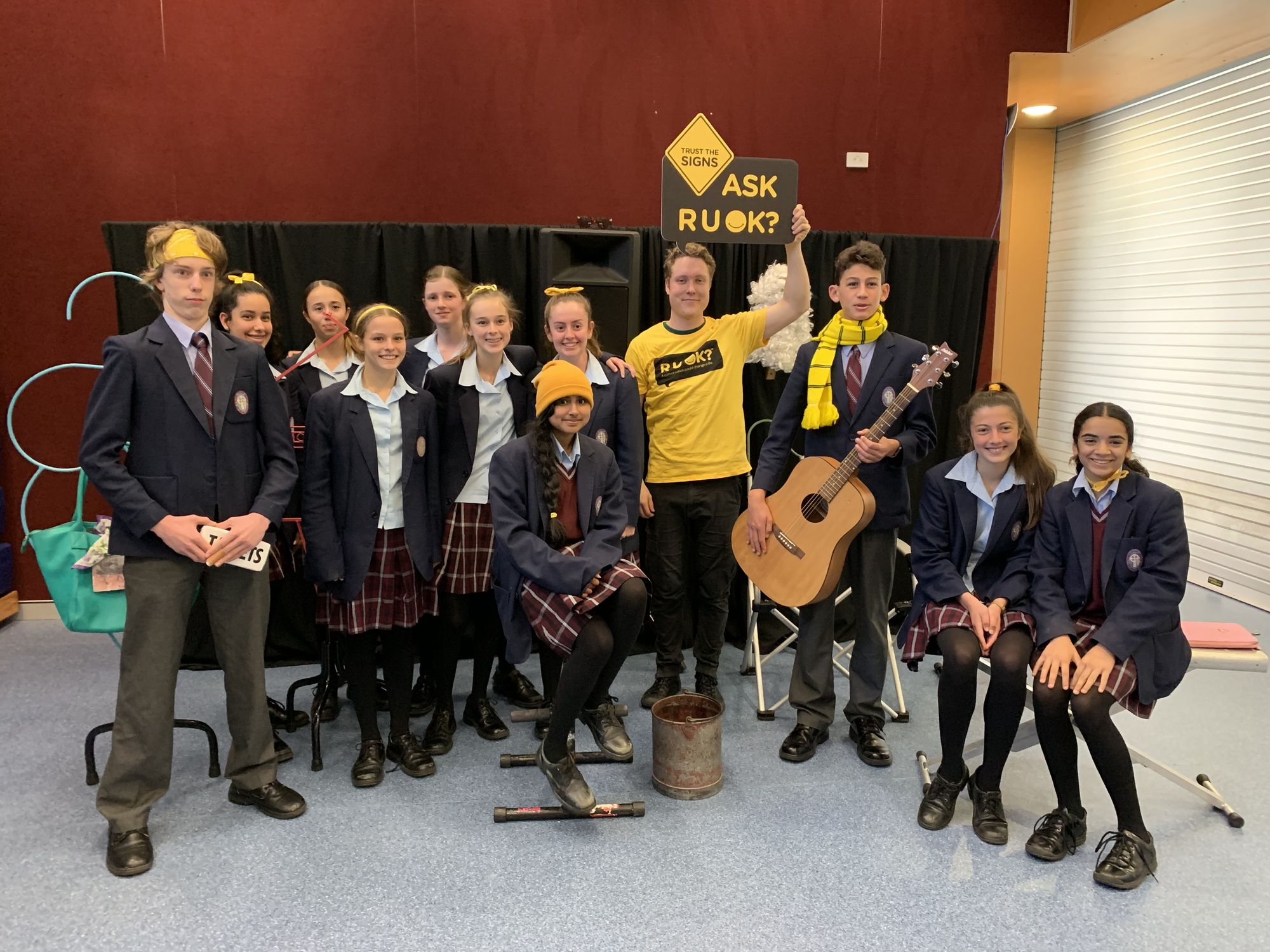 Presenter posing with secondary school students after wellbeing show on ROUK day