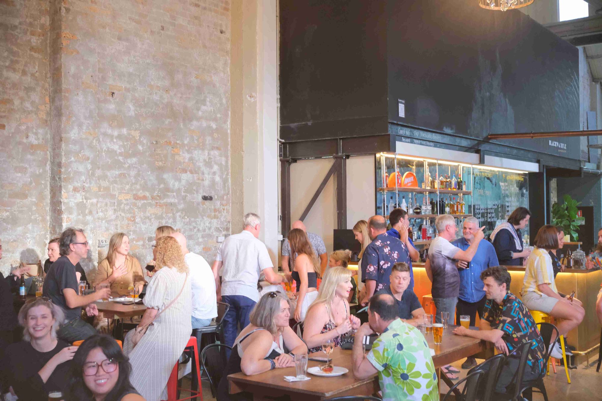 Photo of industrial Chic warehouse filled with people