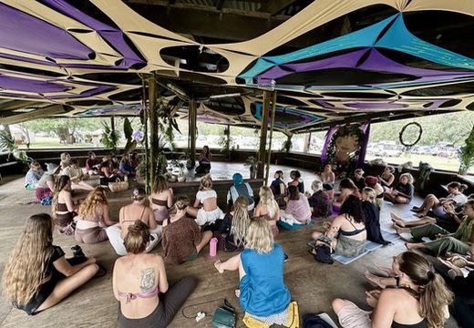 Manu teaching a workshop to a large group at a women's festival