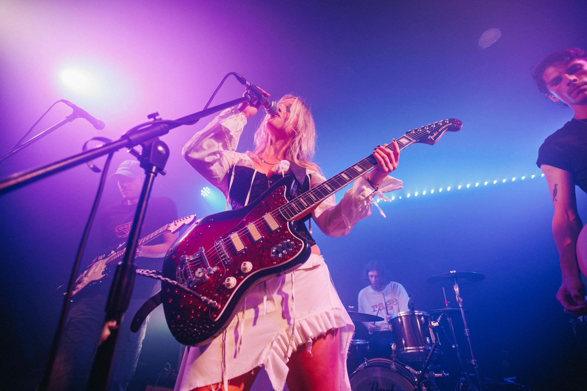 Artist playing guitar on a stage