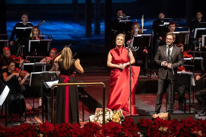 Ana and Igor Durlovski performing with the AYGA Symphony Orchestra on stage in Skopje.