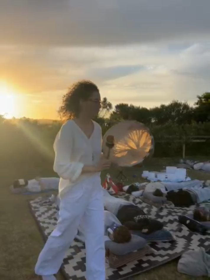 Yifat drumming in an outdoor sound bath