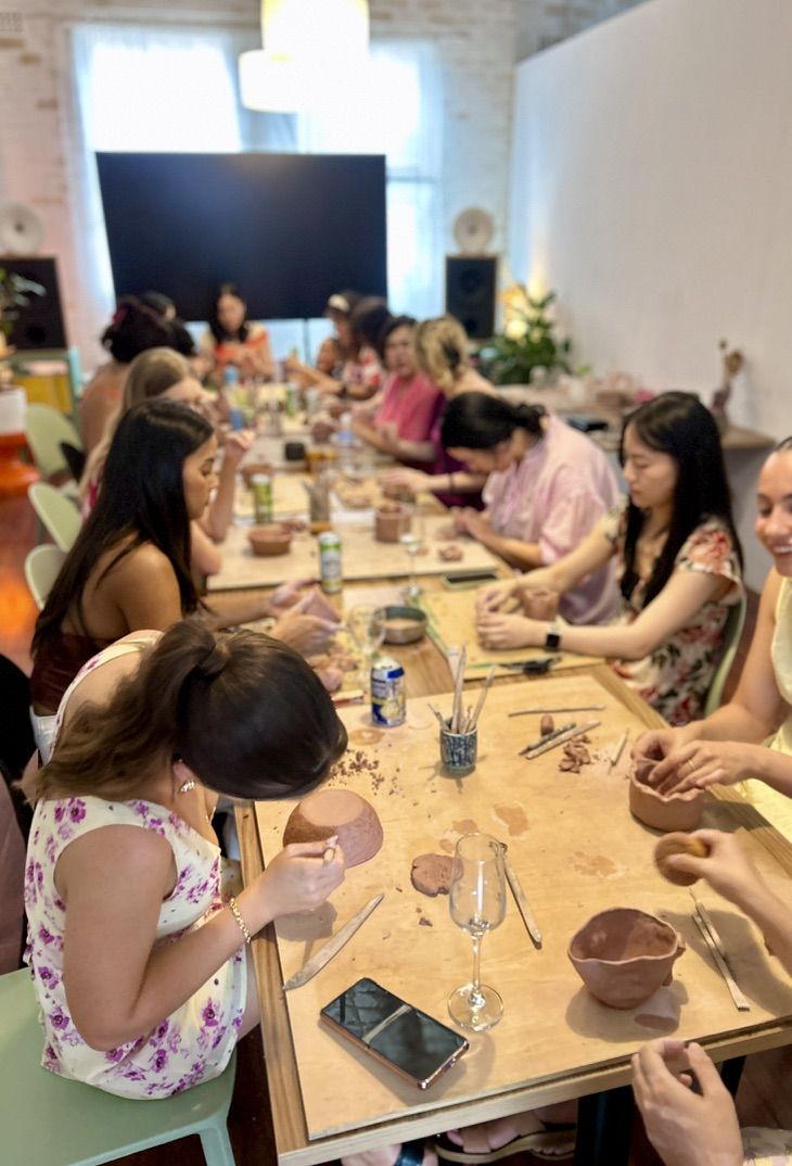 Full room of participants working on their pieces for a hens party