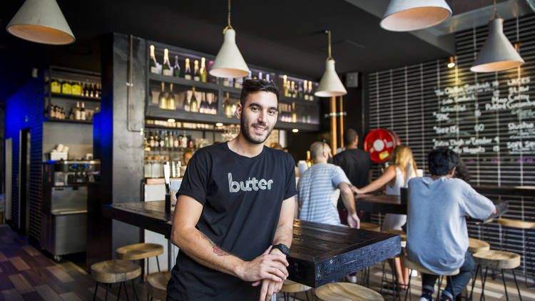 Business owner stands inside his restaurant  