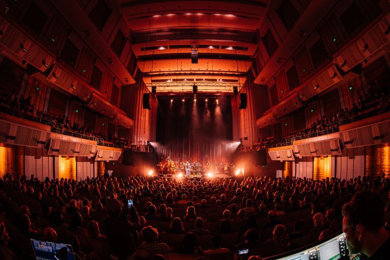A packed City Recital Hall audience watching a big band perform on stage